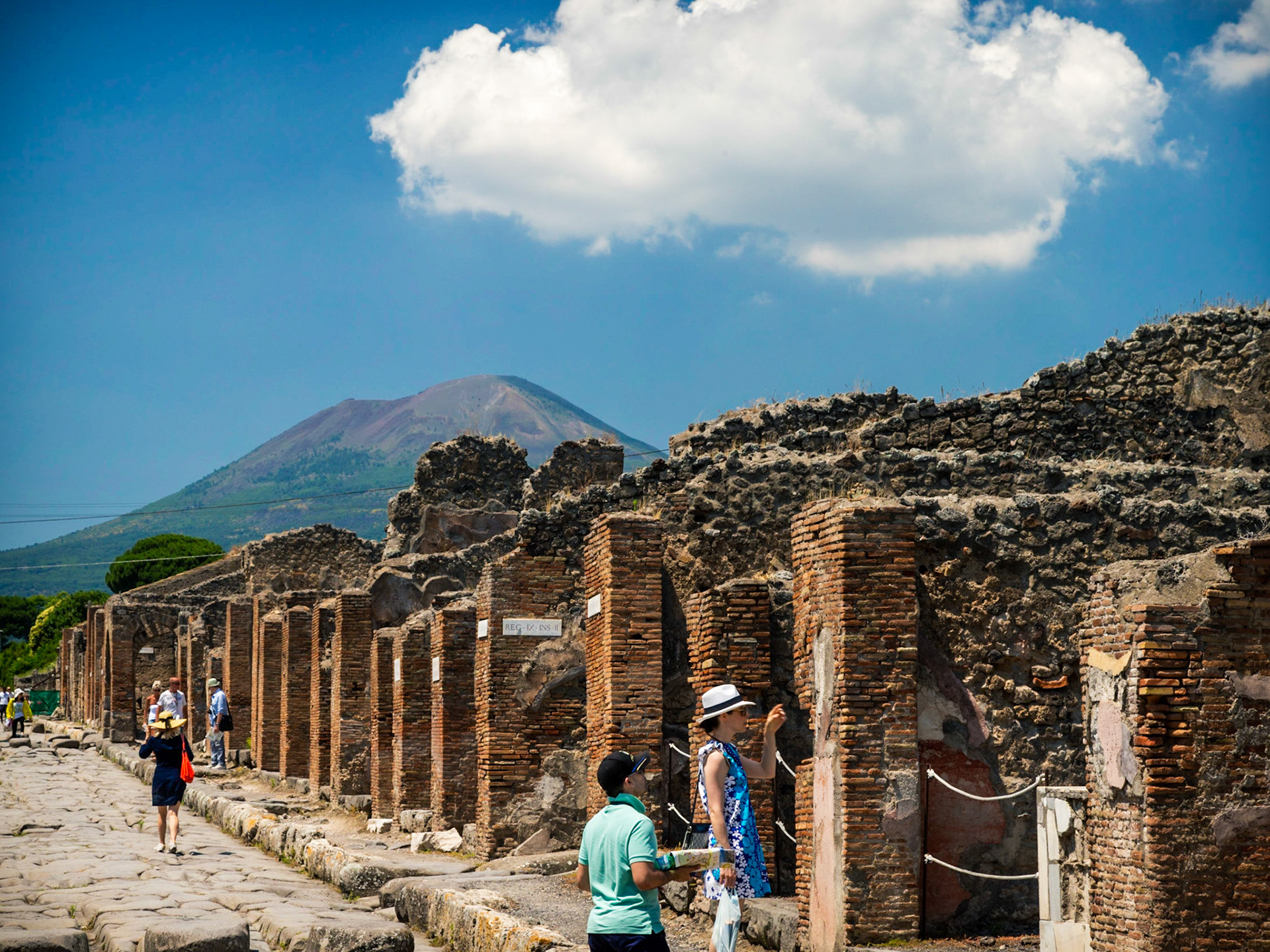 The Ruins Of Pompeii.  Vesuvius Still Dominates The Background As If Waiting To Strike.