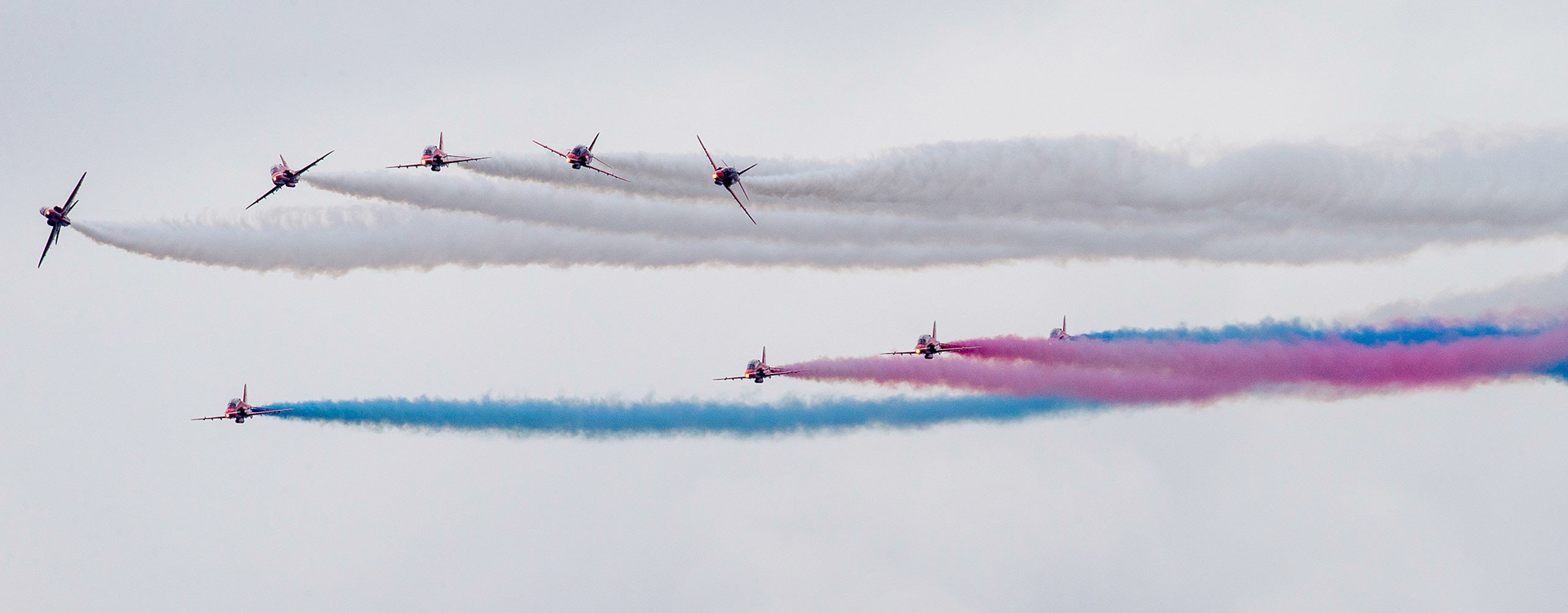 The Red Arrows, officially known as the Royal Air Force Aerobatic Team, is the aerobatics display team of the Royal Air Force based at RAF Scampton. The team was formed in late 1964 as an all-RAF team, replacing a number of unofficial teams that had been sponsored by RAF commands.The Red Arrows badge shows the aircraft in their trademark diamond nine formation, with the motto Éclat, a French word meaning "brilliance" or "excellence".