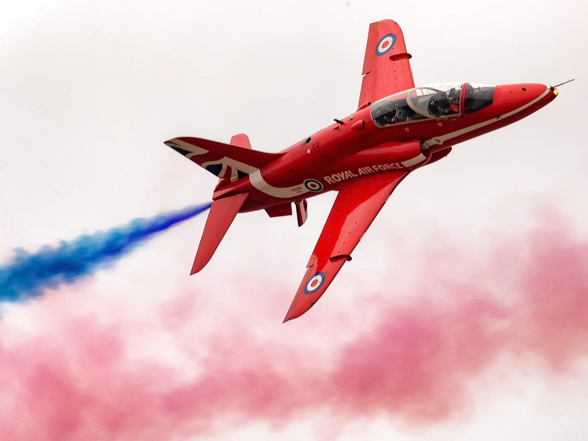 The Red Arrows, officially known as the Royal Air Force Aerobatic Team, is the aerobatics display team of the Royal Air Force based at RAF Scampton. The team was formed in late 1964 as an all-RAF team, replacing a number of unofficial teams that had been sponsored by RAF commands.The Red Arrows badge shows the aircraft in their trademark diamond nine formation, with the motto Éclat, a French word meaning "brilliance" or "excellence".