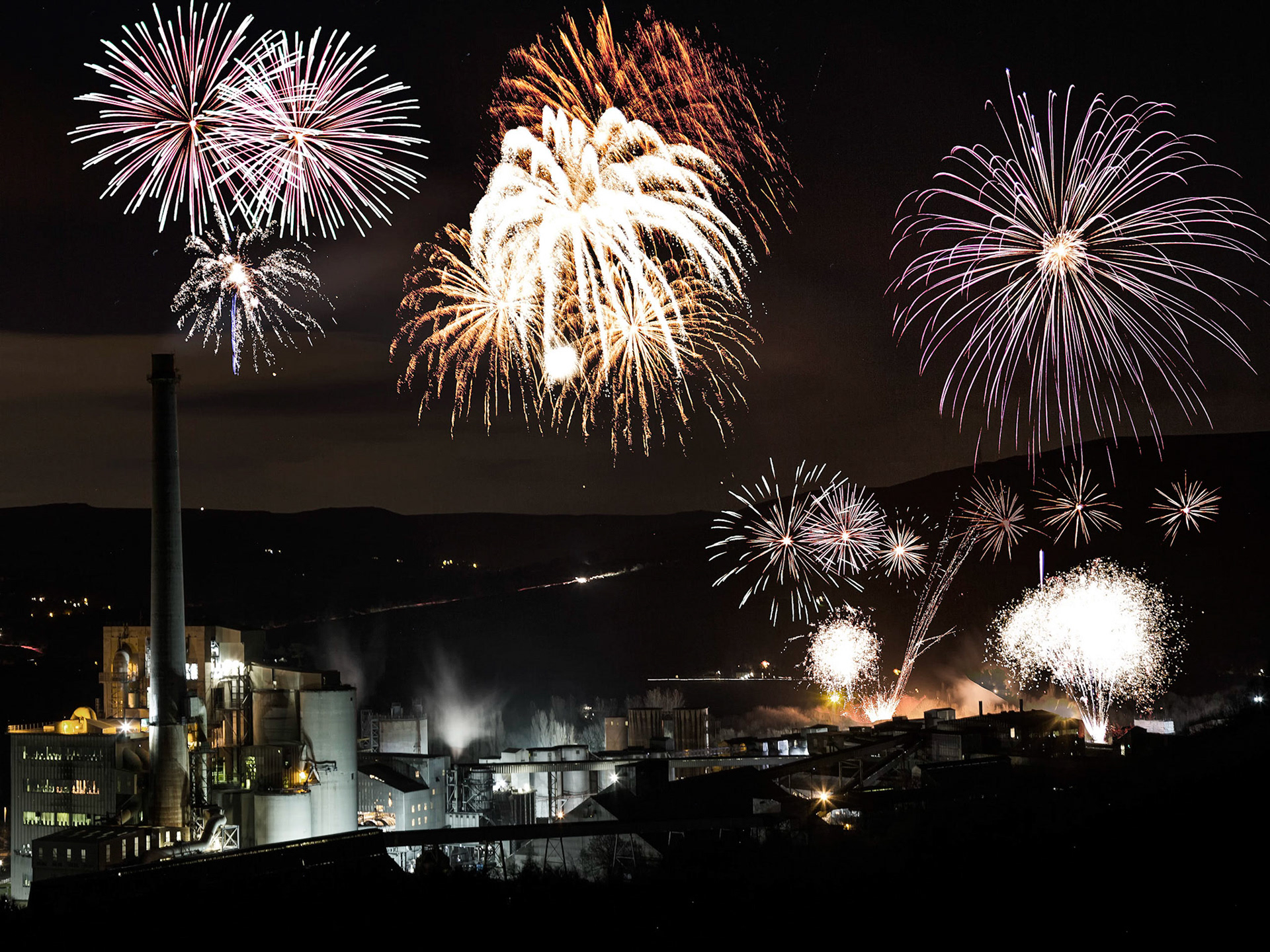 An unusual setting for a firework display, the cement works provides the backdrop for an impressive show.  This is a composite of several images taken at the time and blended later.