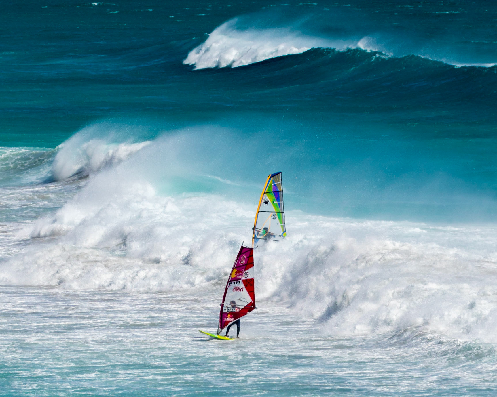 Windsurfing can be said to straddle both the laid-back culture of surf sports and the more rules-based environment of sailing. Although it might be considered a minimalistic version of a sailboat, windsurfing offers experiences that are outside the scope of other sailing craft designs. Windsurfers can perform jumps, inverted loops, spinning maneuvers, and other "freestyle" moves that cannot be matched by any sailboat.