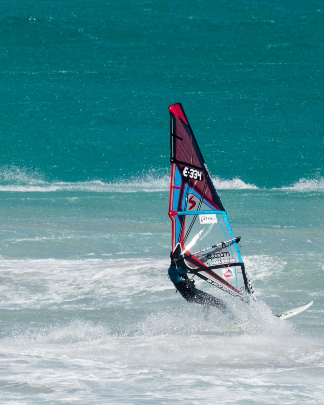 Windsurfing can be said to straddle both the laid-back culture of surf sports and the more rules-based environment of sailing. Although it might be considered a minimalistic version of a sailboat, windsurfing offers experiences that are outside the scope of other sailing craft designs. Windsurfers can perform jumps, inverted loops, spinning maneuvers, and other "freestyle" moves that cannot be matched by any sailboat.