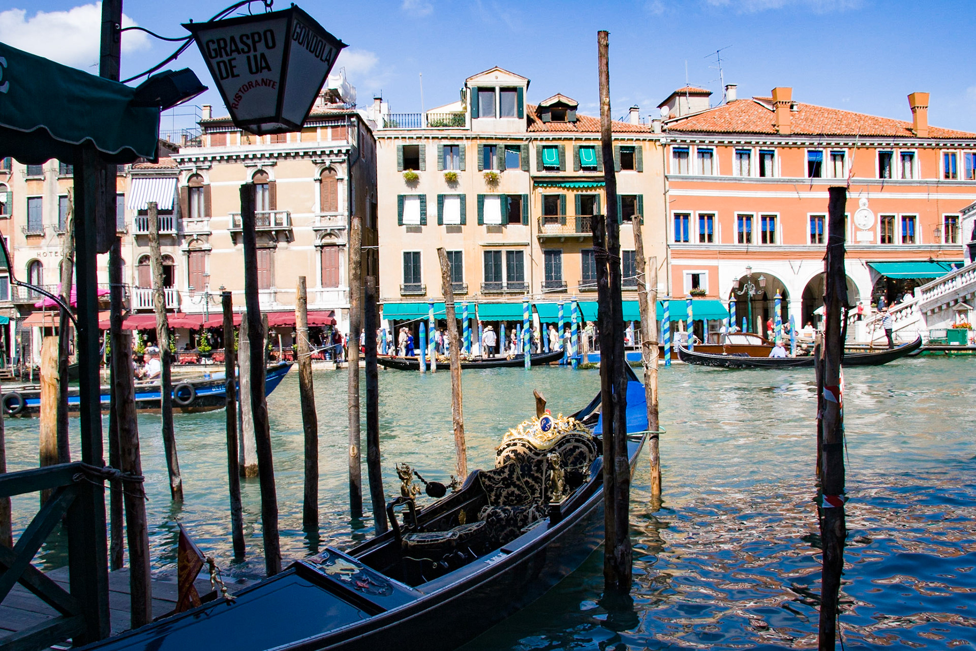 The gondola is a traditional, flat-bottomed Venetian rowing boat, well suited to the conditions of the Venetian lagoon. It is typically propelled by a gondolier, who uses a rowing oar, which is not fastened to the hull, in a sculling manner and also acts as the rudder