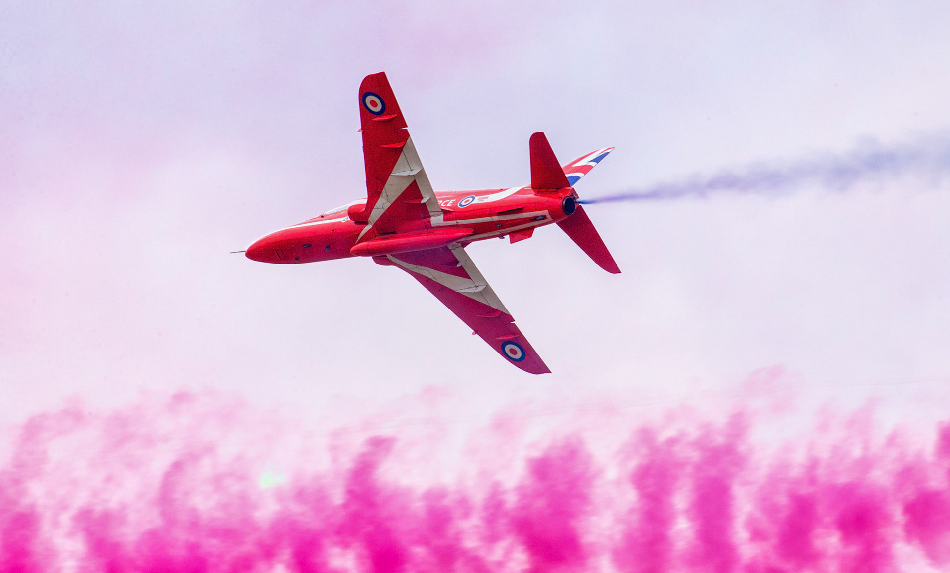 The Red Arrows, officially known as the Royal Air Force Aerobatic Team, is the aerobatics display team of the Royal Air Force based at RAF Scampton. The team was formed in late 1964 as an all-RAF team, replacing a number of unofficial teams that had been sponsored by RAF commands.The Red Arrows badge shows the aircraft in their trademark diamond nine formation, with the motto Éclat, a French word meaning "brilliance" or "excellence".