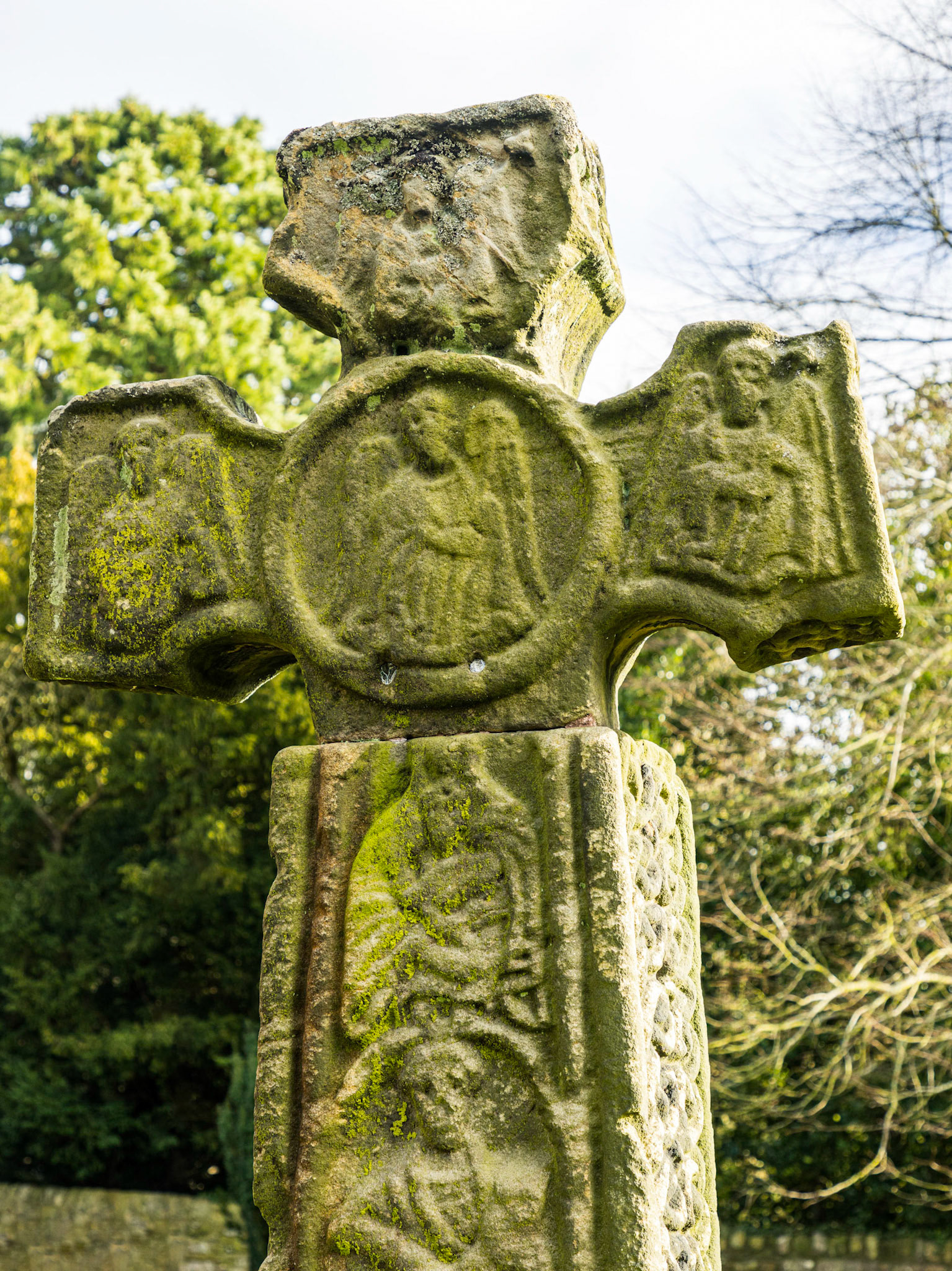 In the churchyard at Eyam is an Anglo-Saxon cross in Mercian style dated to the 8th century, moved there from its original location beside a moorland cart track. Grade I listed and a Scheduled Ancient Monument, it is covered in complex carvings and is almost complete, but for a missing section of the shaft.