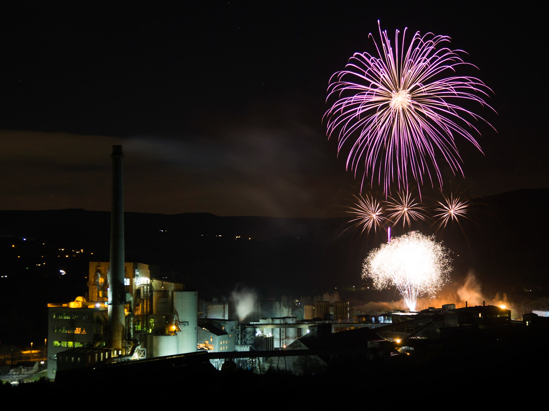 An unusual setting for a firework display, the cement works provides the backdrop for an impressive show.