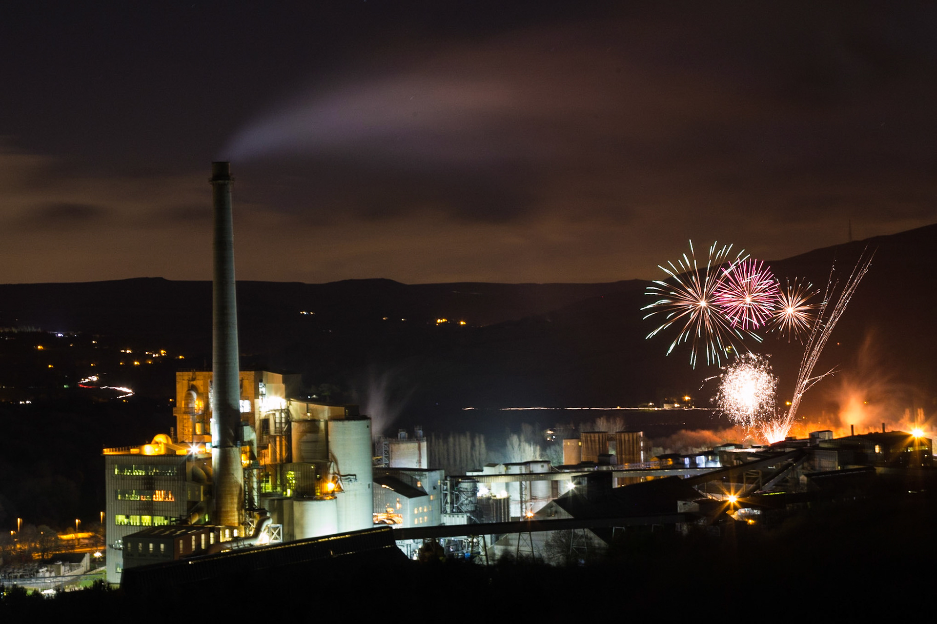 An unusual setting for a firework display, the cement works provides the backdrop for an impressive show.