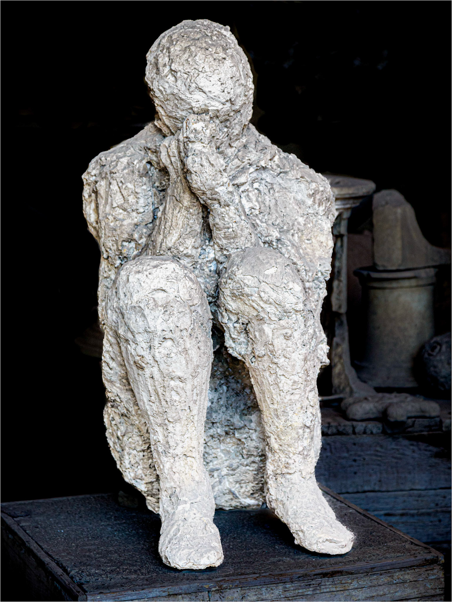 The figure of a person vainly trying to protect themselves from the onslaught of the eruption in 79AD.  This cast was taken from the excavated remains.