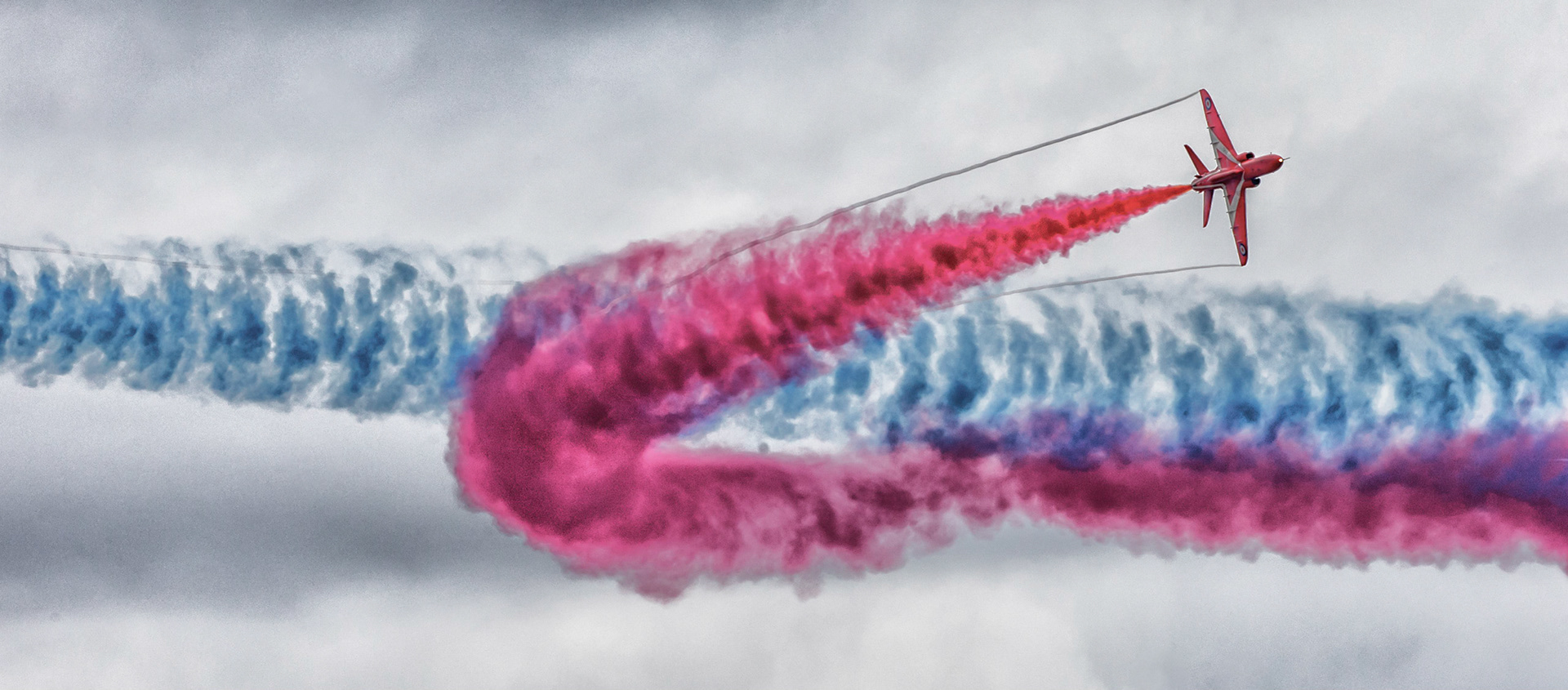 The Red Arrows, officially known as the Royal Air Force Aerobatic Team, is the aerobatics display team of the Royal Air Force based at RAF Scampton. The team was formed in late 1964 as an all-RAF team, replacing a number of unofficial teams that had been sponsored by RAF commands.The Red Arrows badge shows the aircraft in their trademark diamond nine formation, with the motto Éclat, a French word meaning "brilliance" or "excellence".