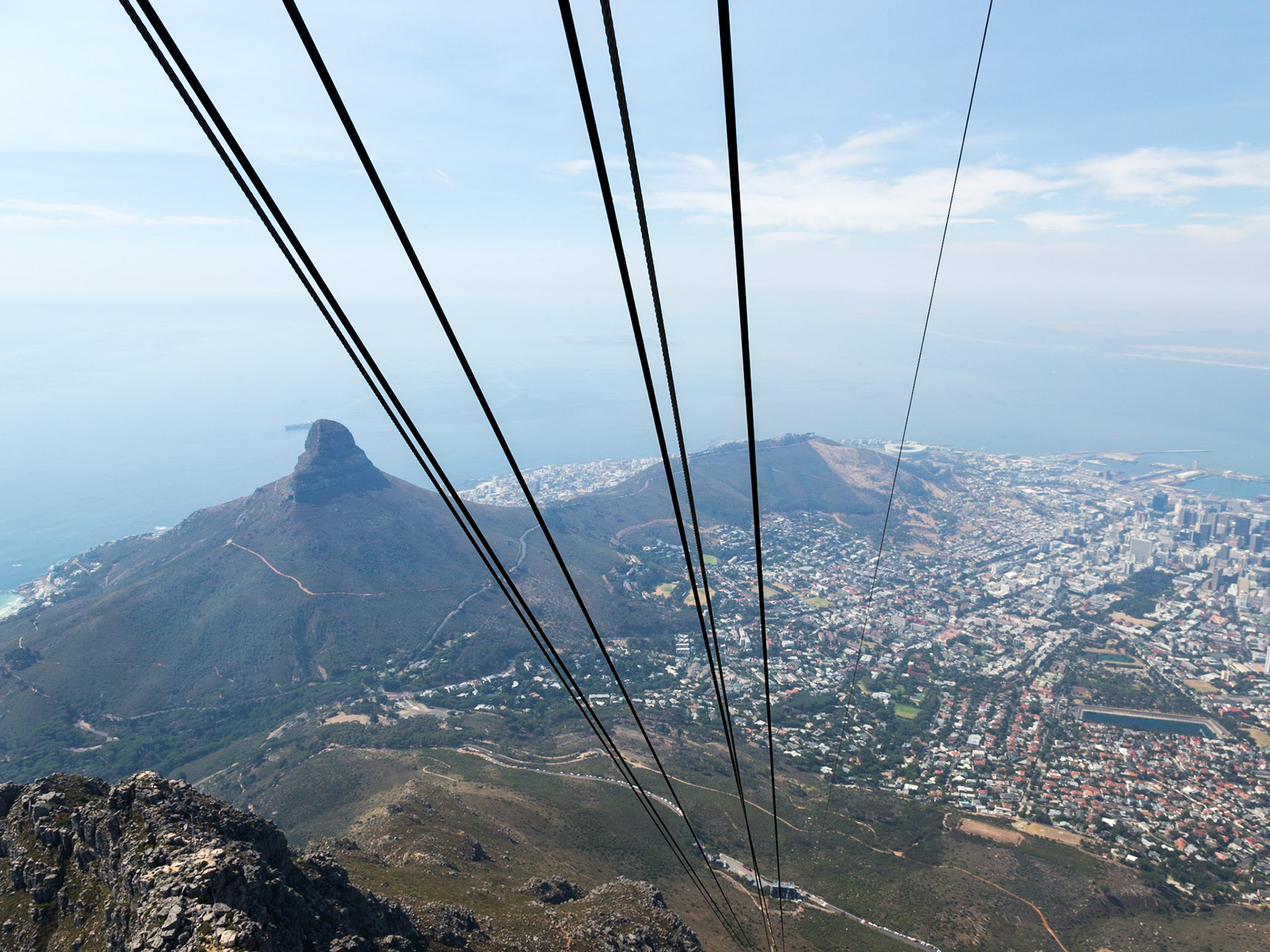 Table Mountain (Khoikhoi: Hoerikwaggo, Afrikaans: Tafelberg) is a flat-topped mountain forming a prominent landmark overlooking the city of Cape Town in South Africa, and is featured in the Flag of Cape Town It is a significant tourist attraction, with many visitors using the cableway or hiking to the top. The mountain forms part of the Table Mountain National Park.