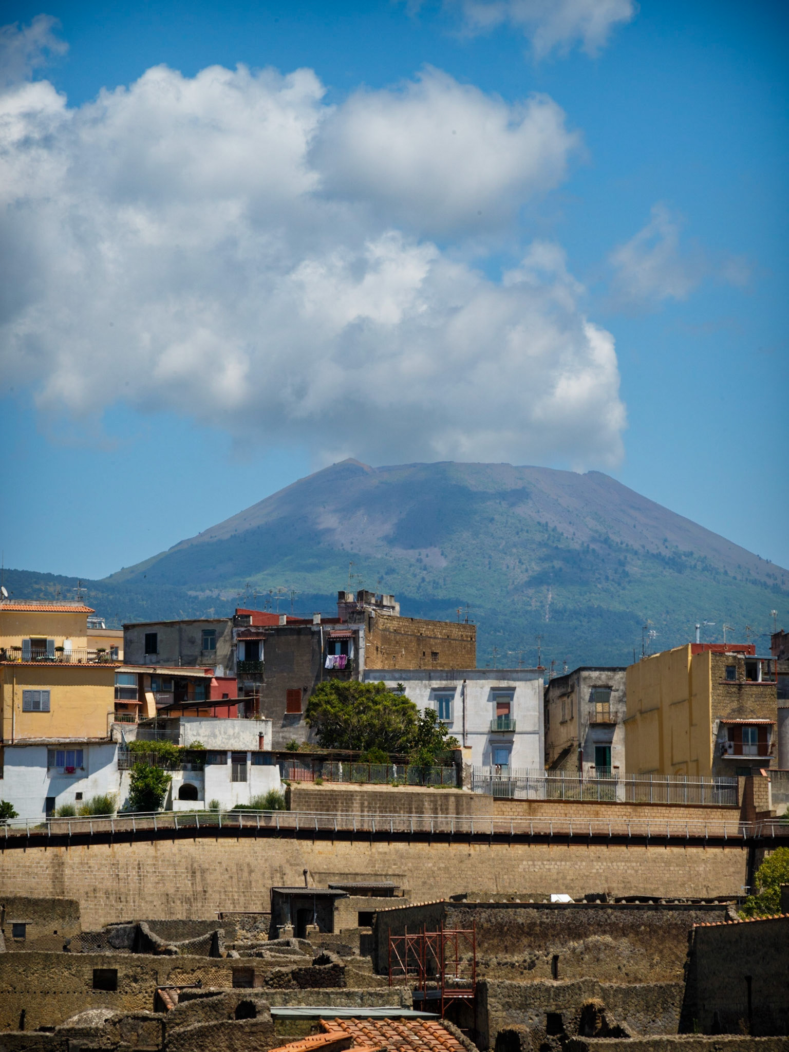 A View Over Herculaneum, With Vesuvius Still Ominous In The Background
