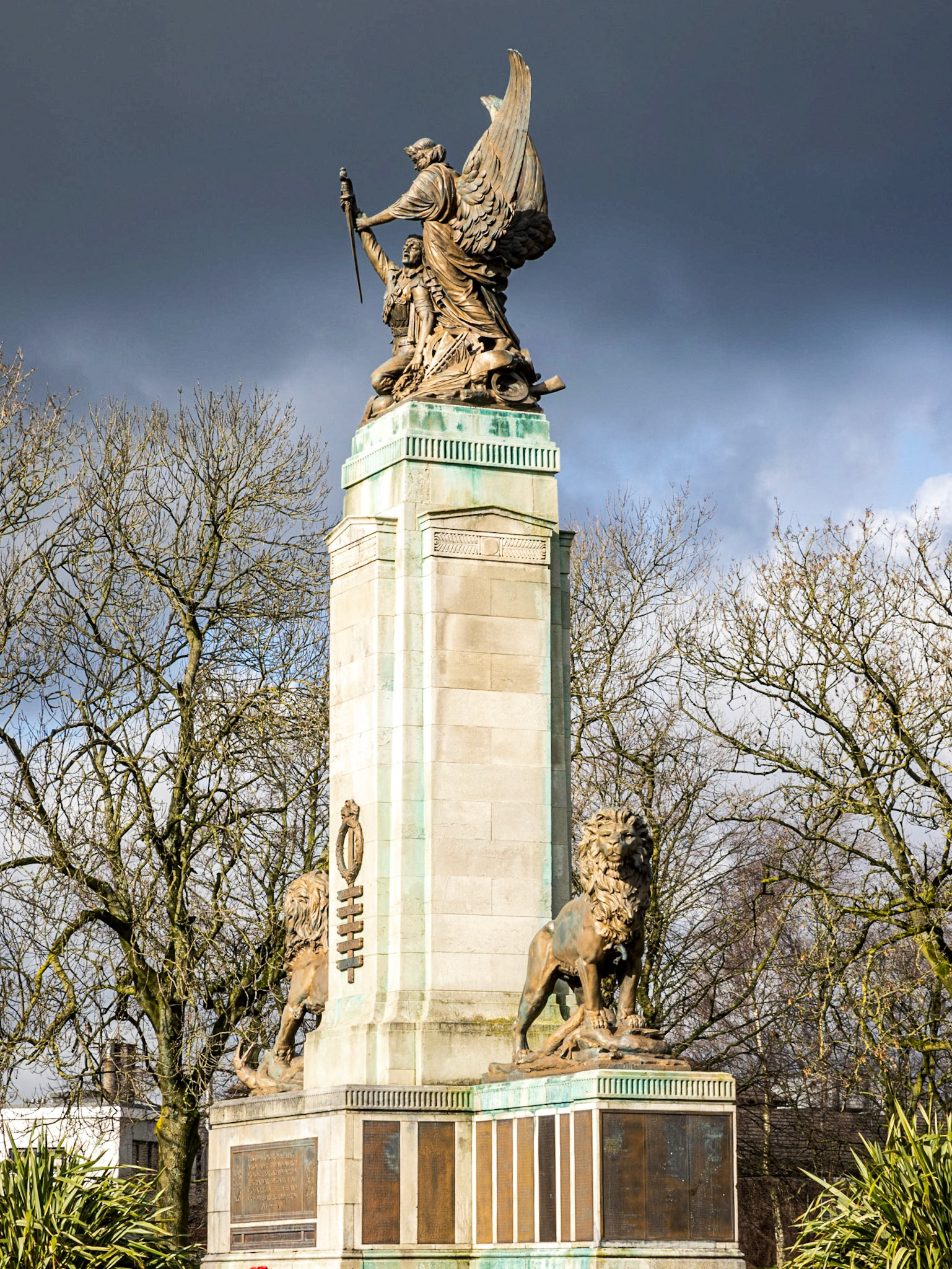 The memorial is 35ft high and built from 50 tons of Portland stone. The crowning group, comprising a wounded soldier figure and the winged figure of peace, is made of bronze and weighs two tons. The soldier, wounded and exhausted, holds a spray of laurels in his bandaged left hand. The winged figure of peace supports him, taking the sword of honour, which he holds. The soldier, having received the laurels of everlasting gratitude, hands over his sword, the symbol of justice, which the winged figure takes into her keeping.