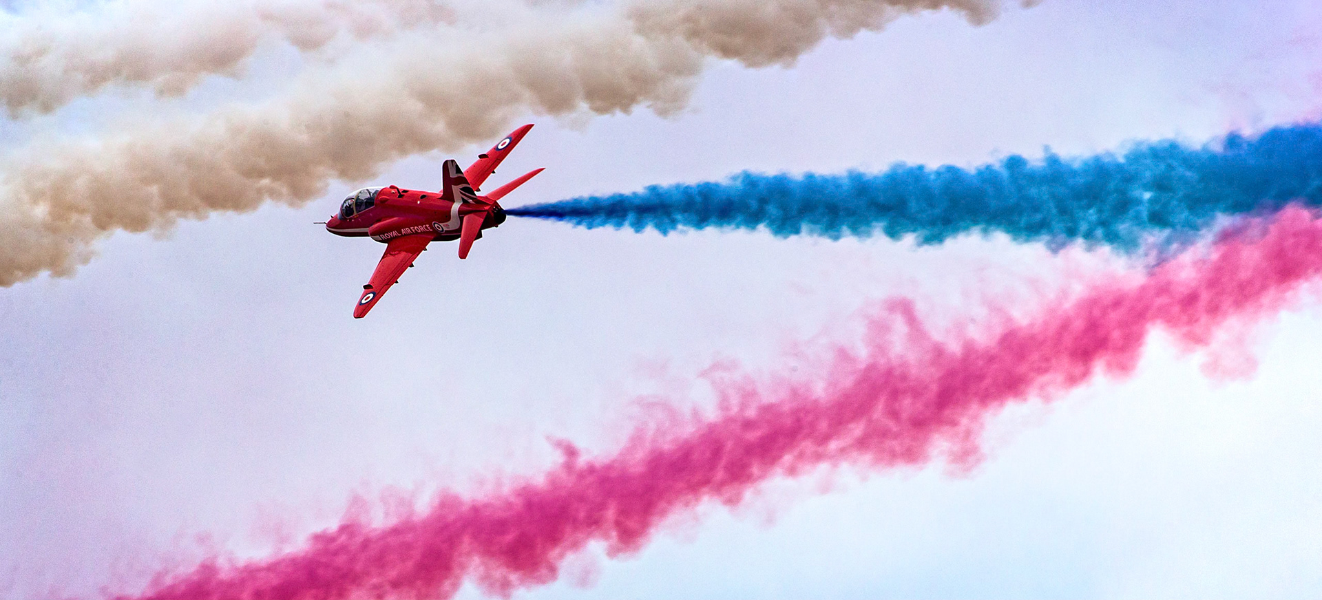 The Red Arrows, officially known as the Royal Air Force Aerobatic Team, is the aerobatics display team of the Royal Air Force based at RAF Scampton. The team was formed in late 1964 as an all-RAF team, replacing a number of unofficial teams that had been sponsored by RAF commands.The Red Arrows badge shows the aircraft in their trademark diamond nine formation, with the motto Éclat, a French word meaning "brilliance" or "excellence".