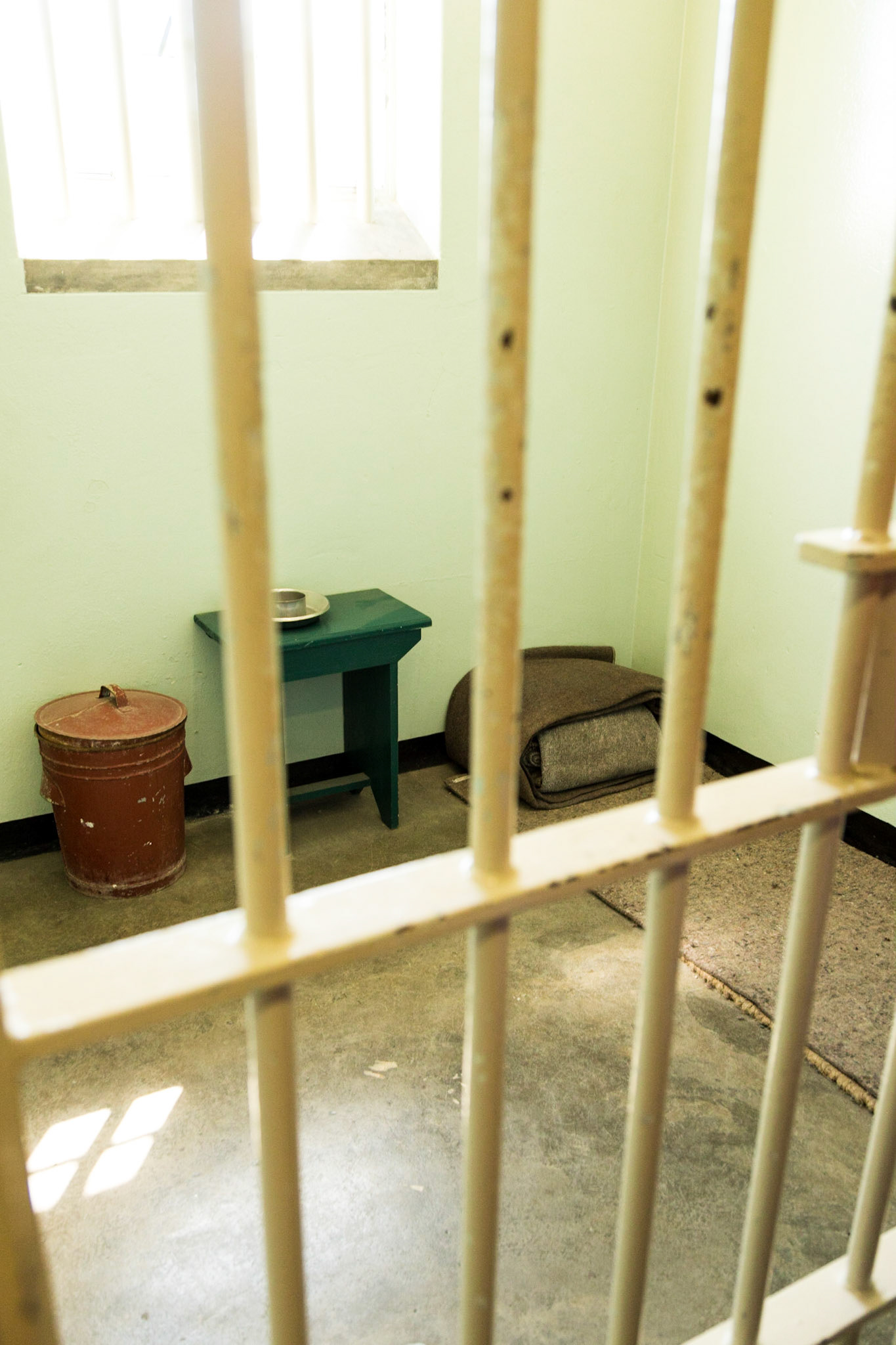 Robben Island is an island in Table Bay, 6.9 km west of Cape Town, South Africa. Robben Island is roughly oval in shape, 3.3 km long north-south, and 1.9 km wide, with an area of 5.07 km². It is flat and only a few metres above sea level. Nobel Laureate and former President of South Africa Nelson Mandela was imprisoned there for 18 of the 27 years he served behind bars before the fall of apartheid. Robben Island is both a South African National Heritage Site as well as a UNESCO World Heritage Site. The Island was used as a prison for political prisoners and convicted criminals from 1961. It was a maximum security prison for political prisoners until 1991. The medium security prison for criminal prisoners was closed in 1996.