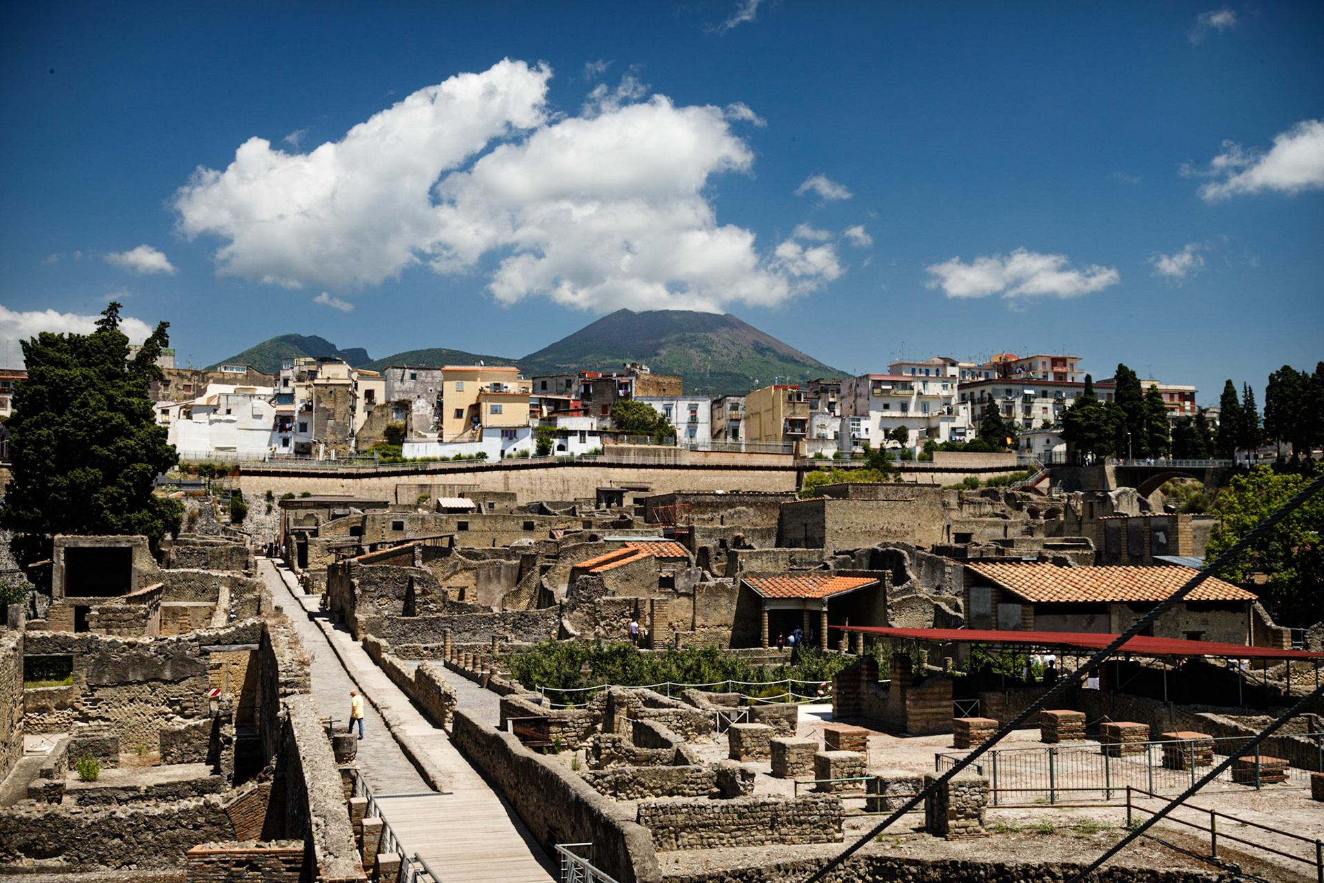 View Over The Ruins Of Herculaneum, With Vesusivius Ominous In The Background