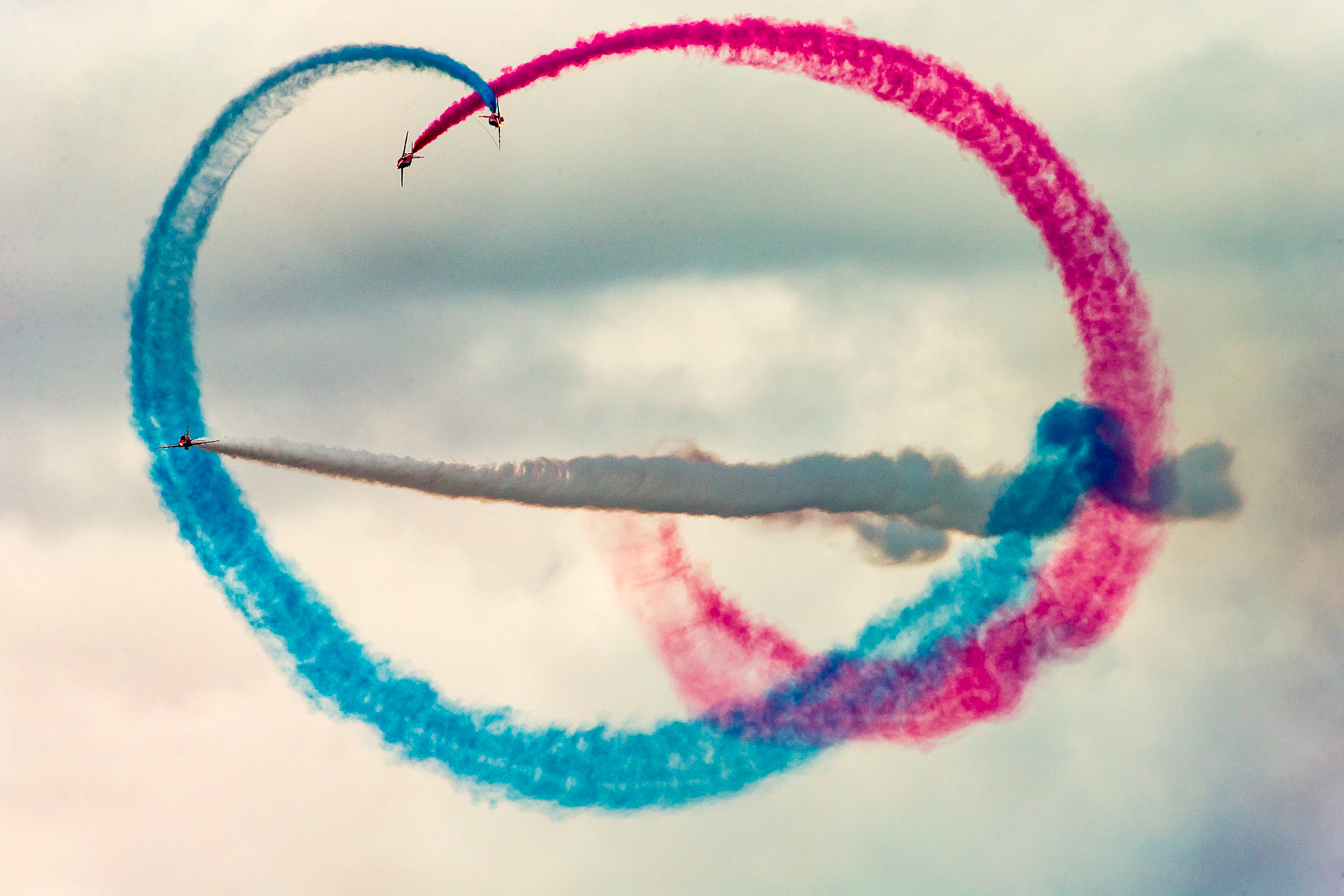 The Red Arrows, officially known as the Royal Air Force Aerobatic Team, is the aerobatics display team of the Royal Air Force based at RAF Scampton. The team was formed in late 1964 as an all-RAF team, replacing a number of unofficial teams that had been sponsored by RAF commands.The Red Arrows badge shows the aircraft in their trademark diamond nine formation, with the motto Éclat, a French word meaning "brilliance" or "excellence".