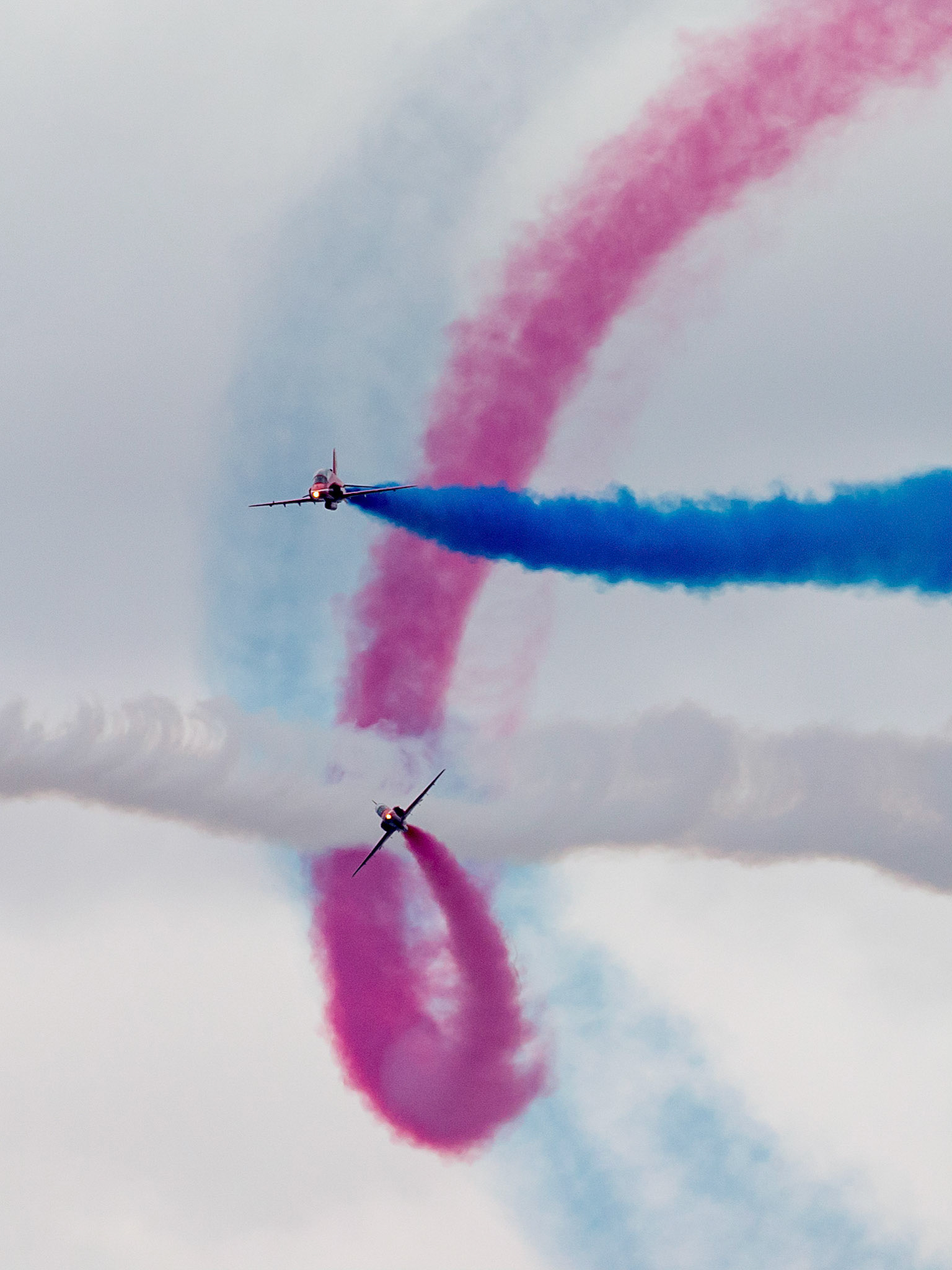 The Red Arrows, officially known as the Royal Air Force Aerobatic Team, is the aerobatics display team of the Royal Air Force based at RAF Scampton. The team was formed in late 1964 as an all-RAF team, replacing a number of unofficial teams that had been sponsored by RAF commands.The Red Arrows badge shows the aircraft in their trademark diamond nine formation, with the motto Éclat, a French word meaning "brilliance" or "excellence".