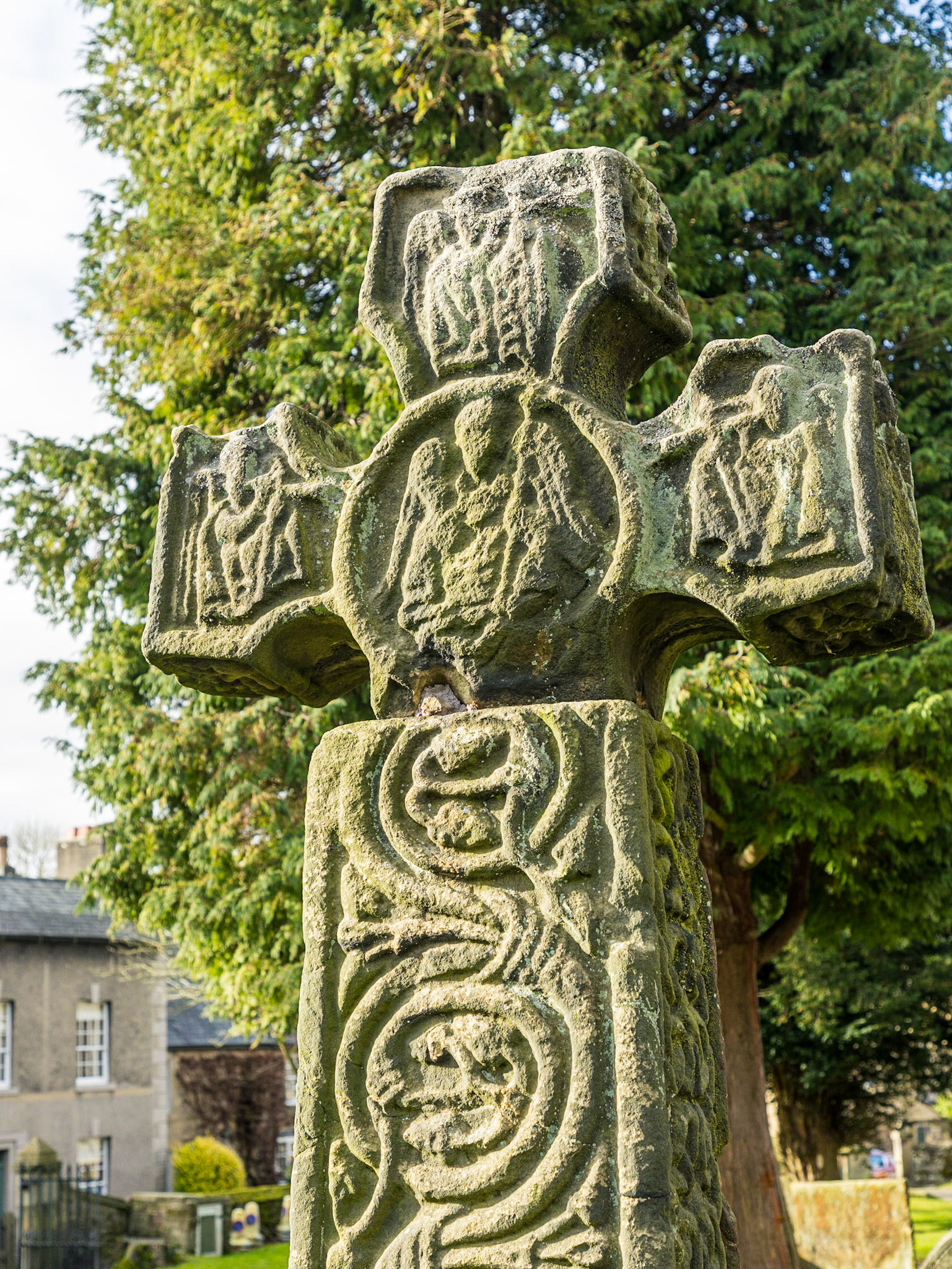 In the churchyard is an Anglo-Saxon cross in Mercian style dated to the 8th century, moved there from its original location beside a moorland cart track. Grade I listed and a Scheduled Ancient Monument,[9] it is covered in complex carvings and is almost complete, but for a missing section of the shaft.