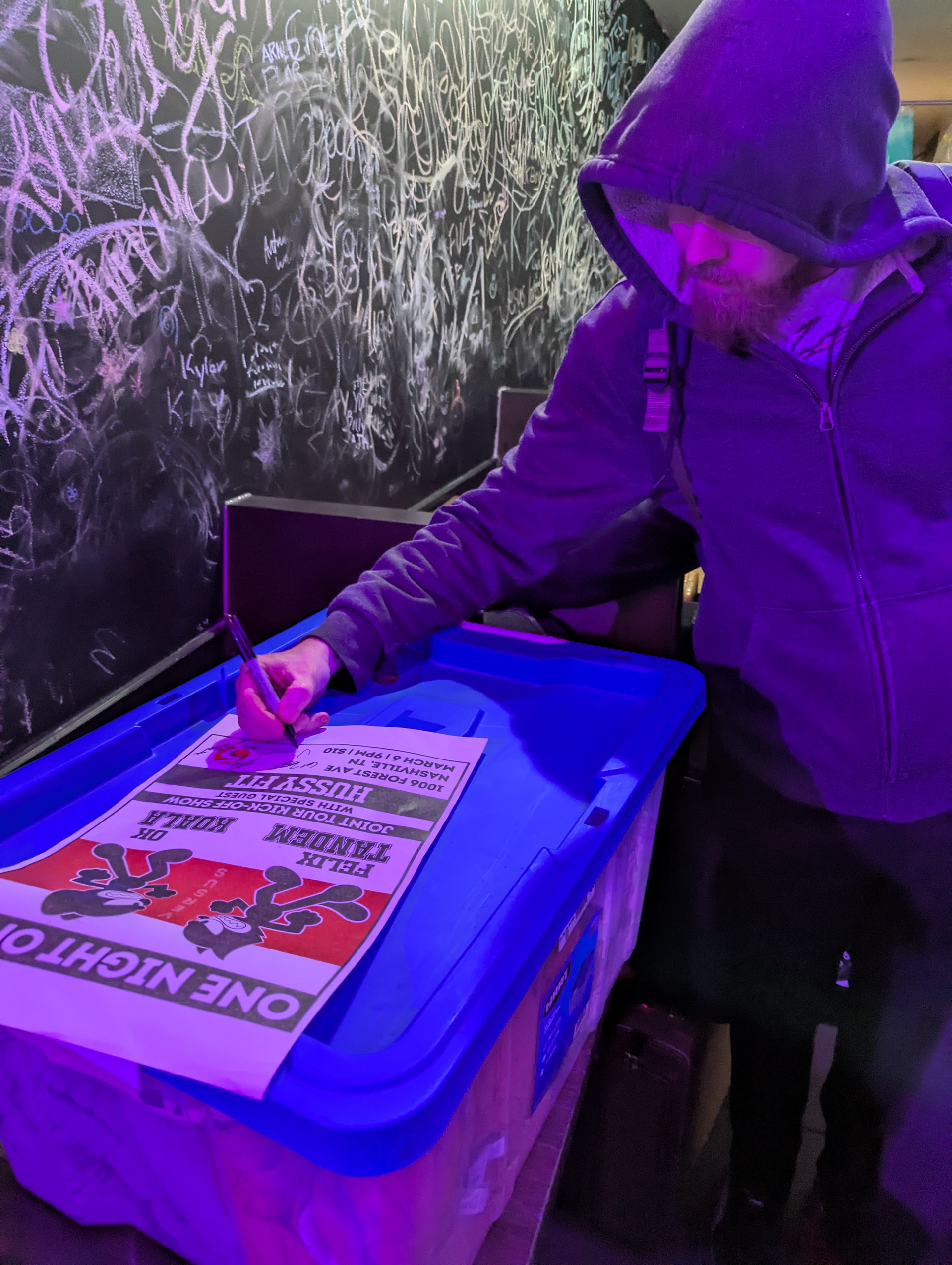 Signing a poster for a fan