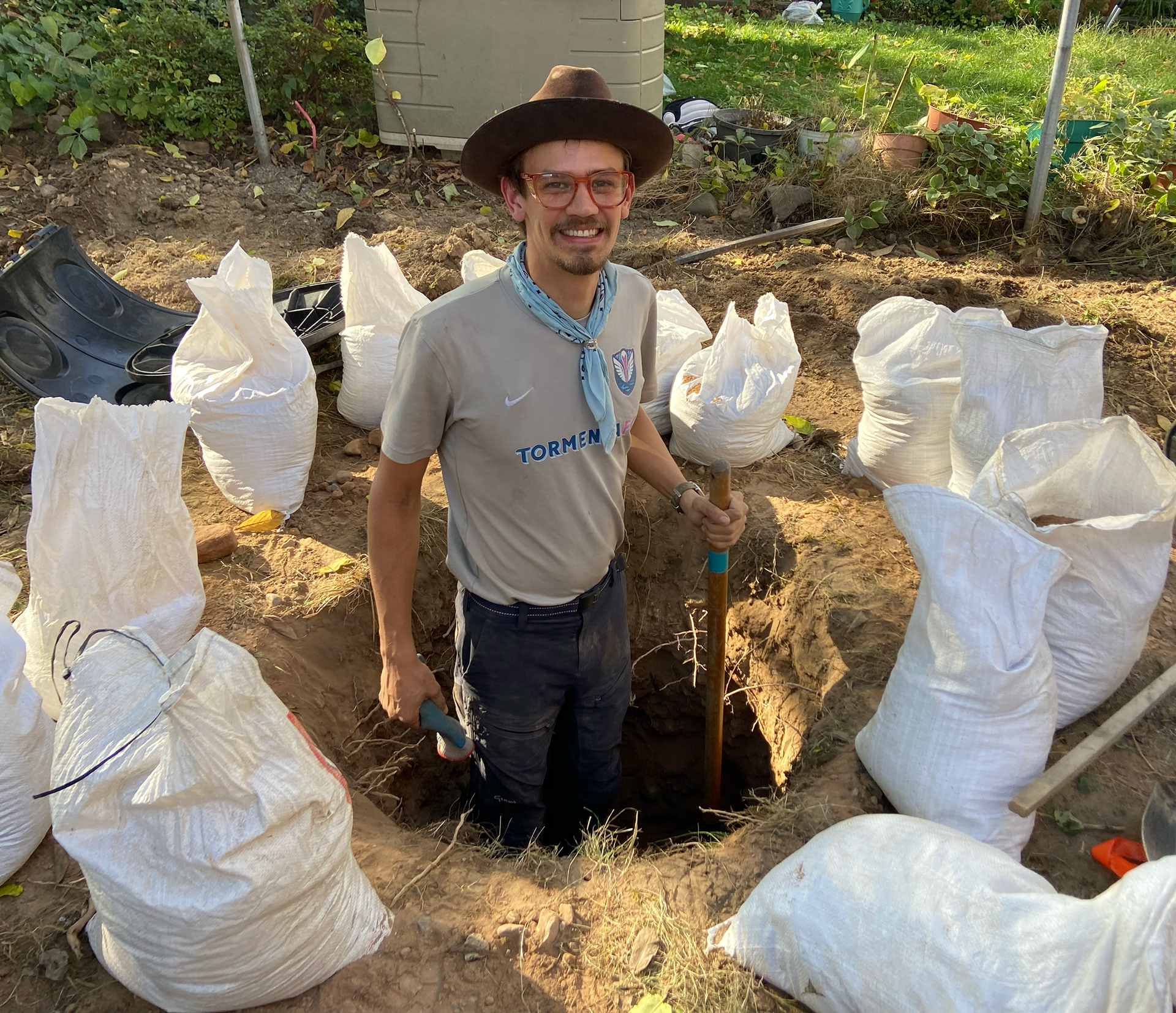 Whitt digging a hole for a dry well