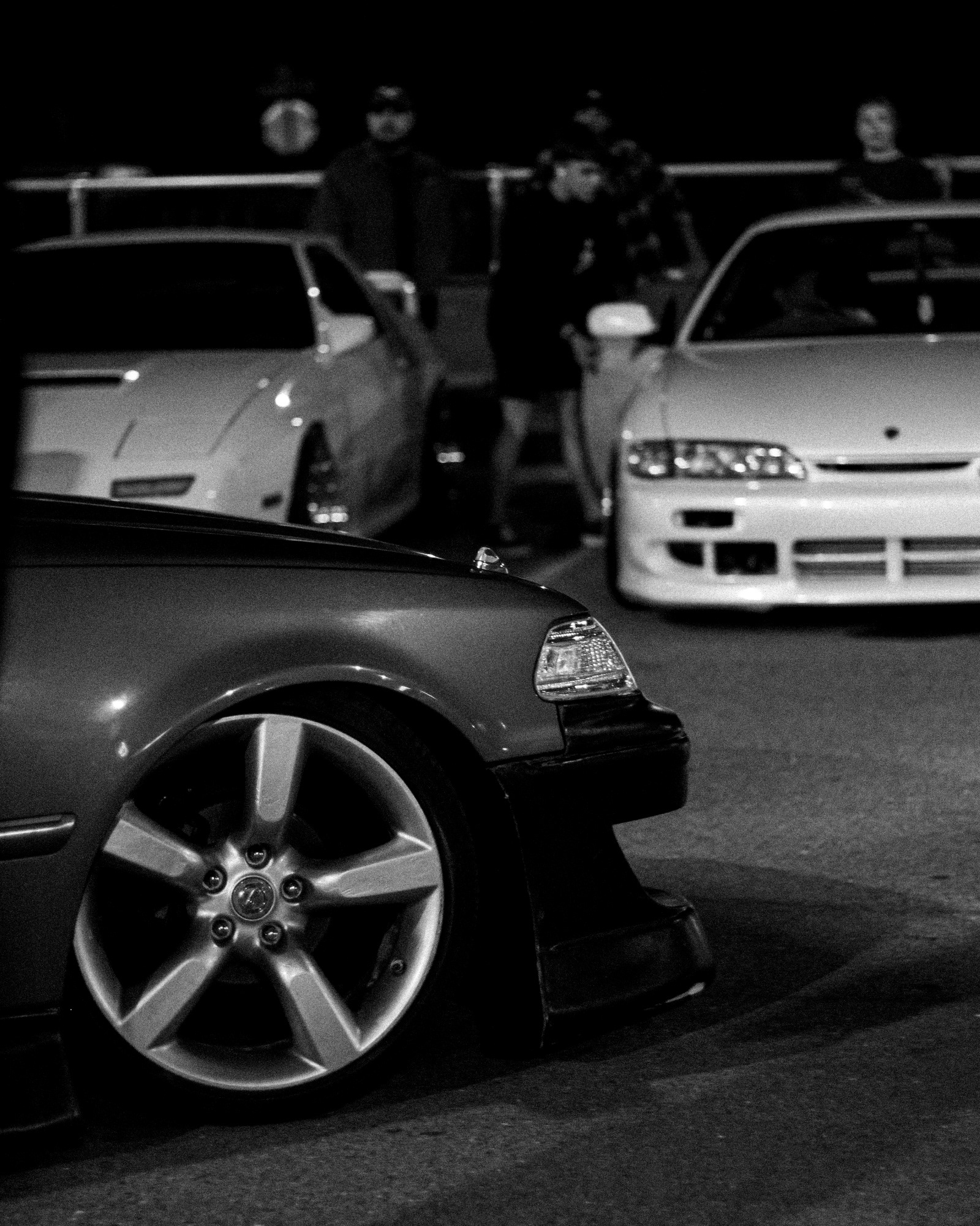 Car meet in a parking lot at night