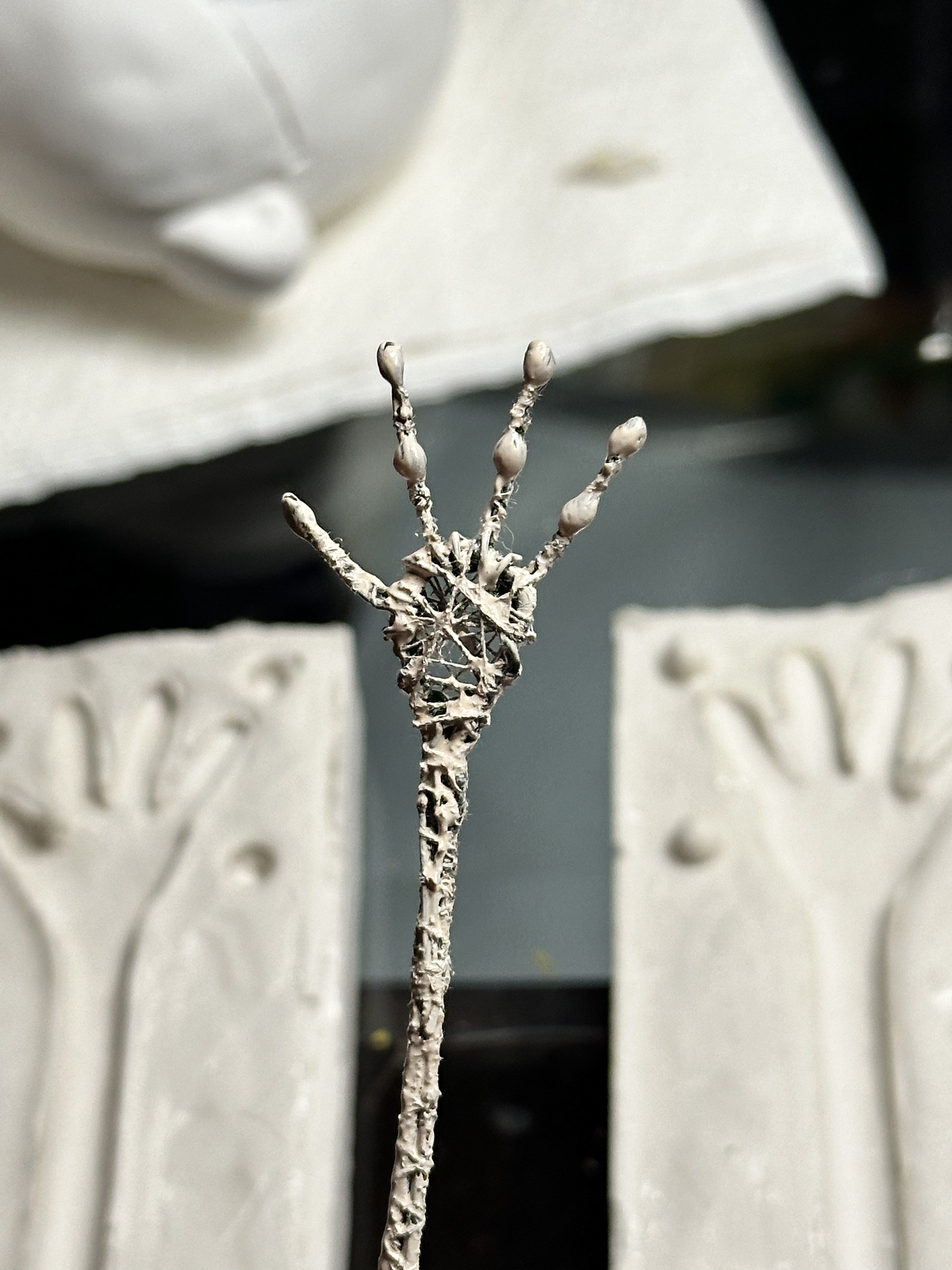 Hand armature with thread & resin joints coated in paint pre-casting