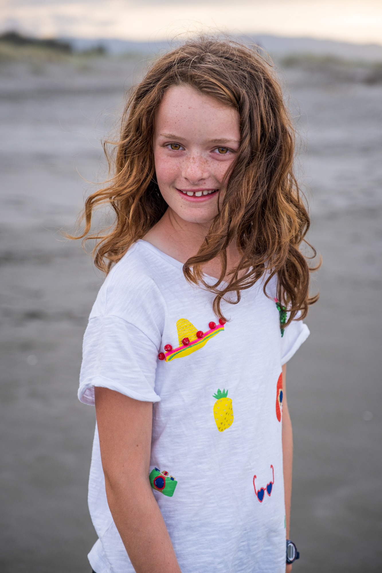portrait of a girl taken on the beach during a family photo shoot in the Bay of Plenty