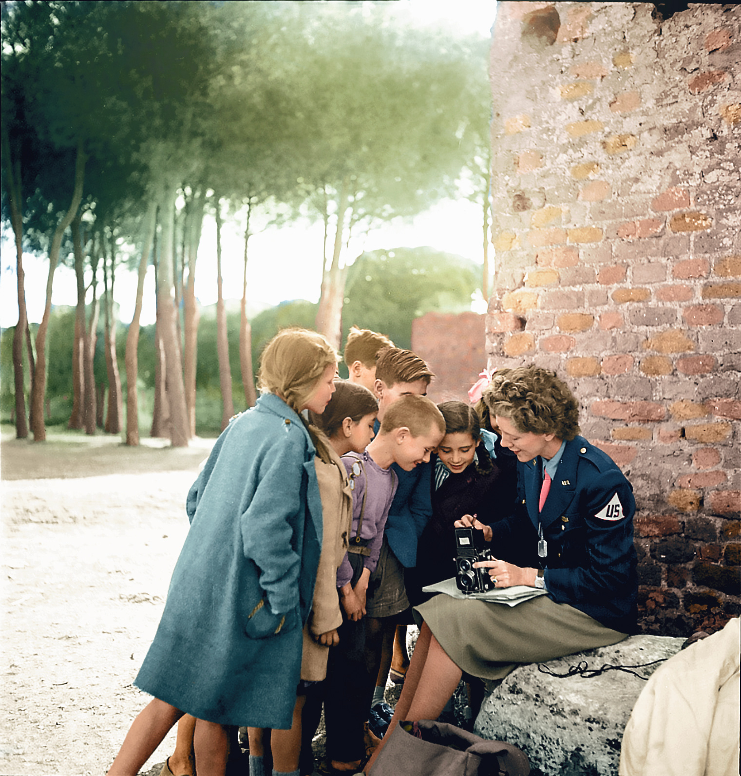“Toni Frissell, sitting, holding camera on her lap, with several children standing around her, somewhere in Europe” 📷 Frissell, Toni, c. 1945  Original image from @librarycongress