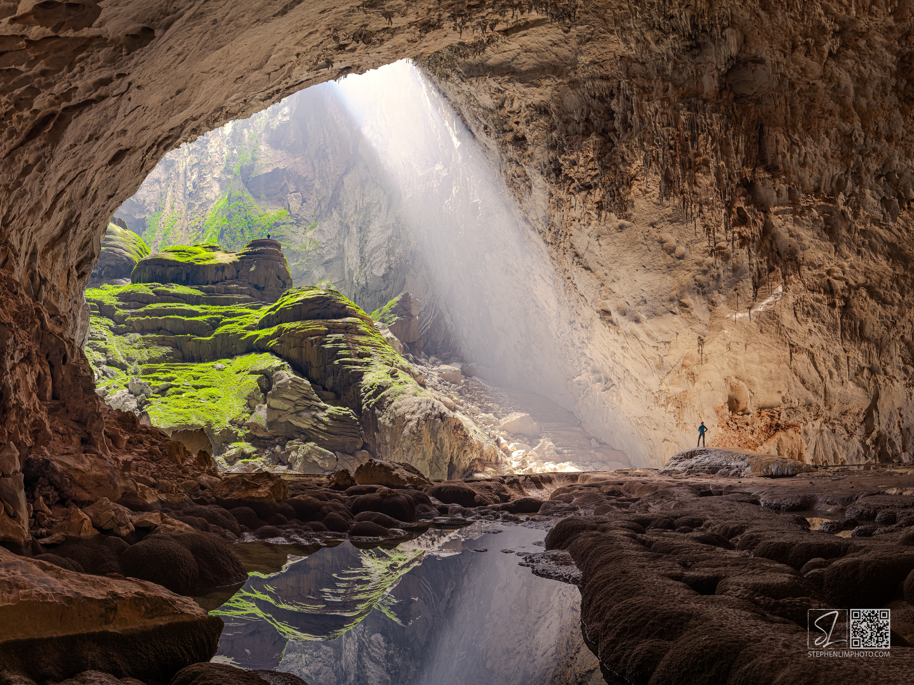 Waiting for Enlightenment:  Cavers exploring Son Doong  with a sunbeam and reflection