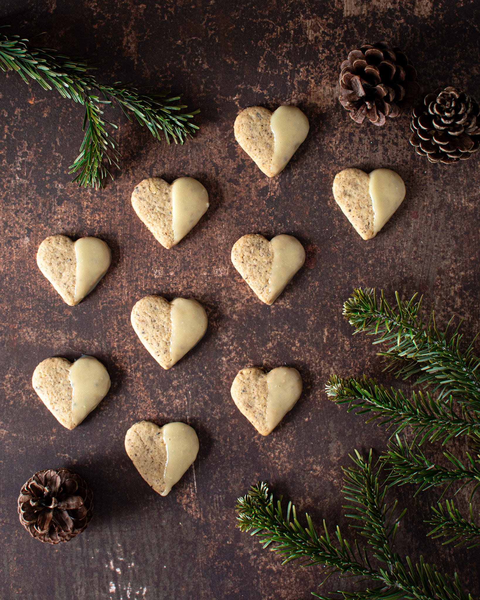 christmas heart shaped cookies, pine branches and pine cones