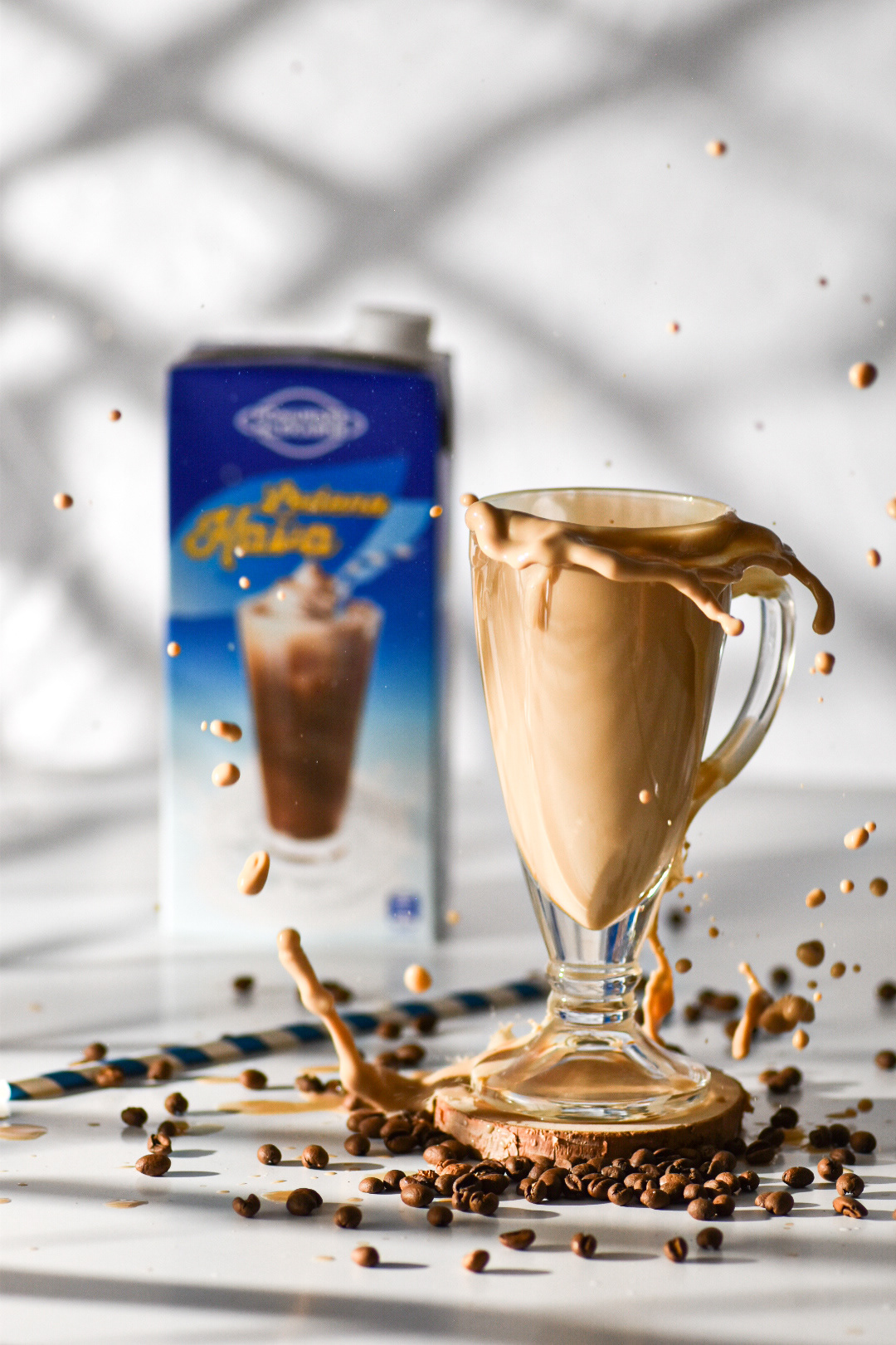 Splash of iced coffee with product in the background