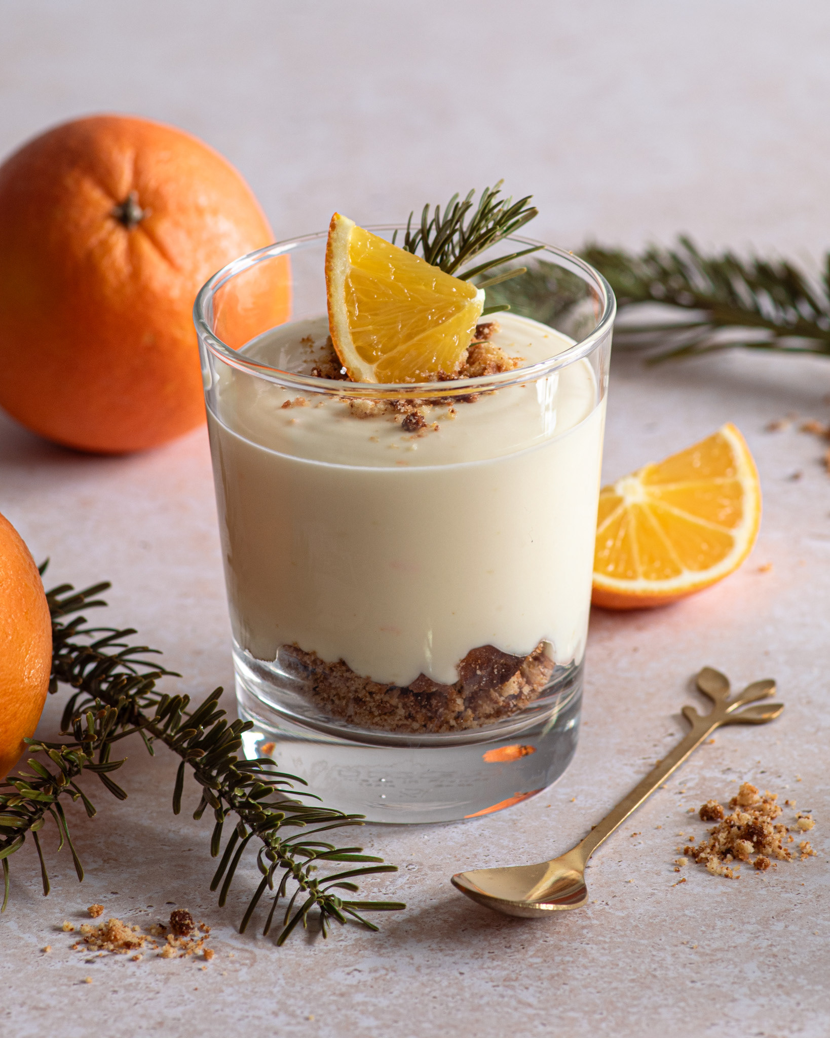 orange dessert cup with cookies and pine branches