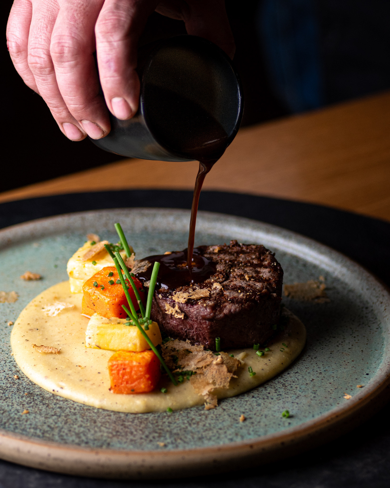 filet mignon with vegetables and pouring sauce