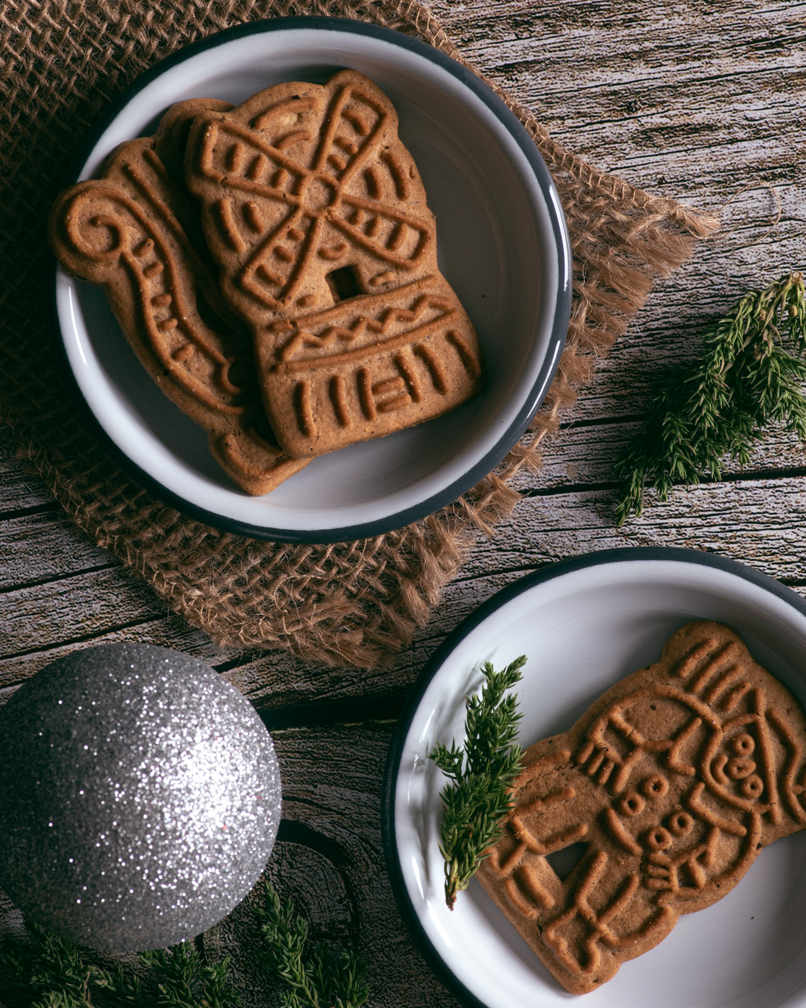 Speculoos cookies on a plate with pine branches and ornament