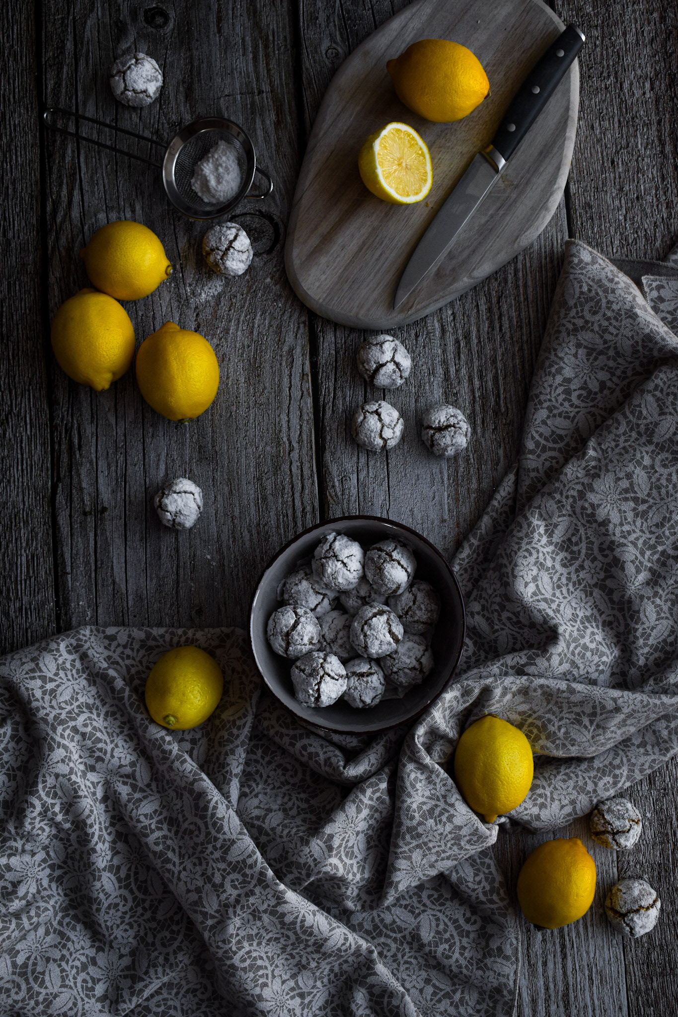 Lemon almond cookies on dark wooden background