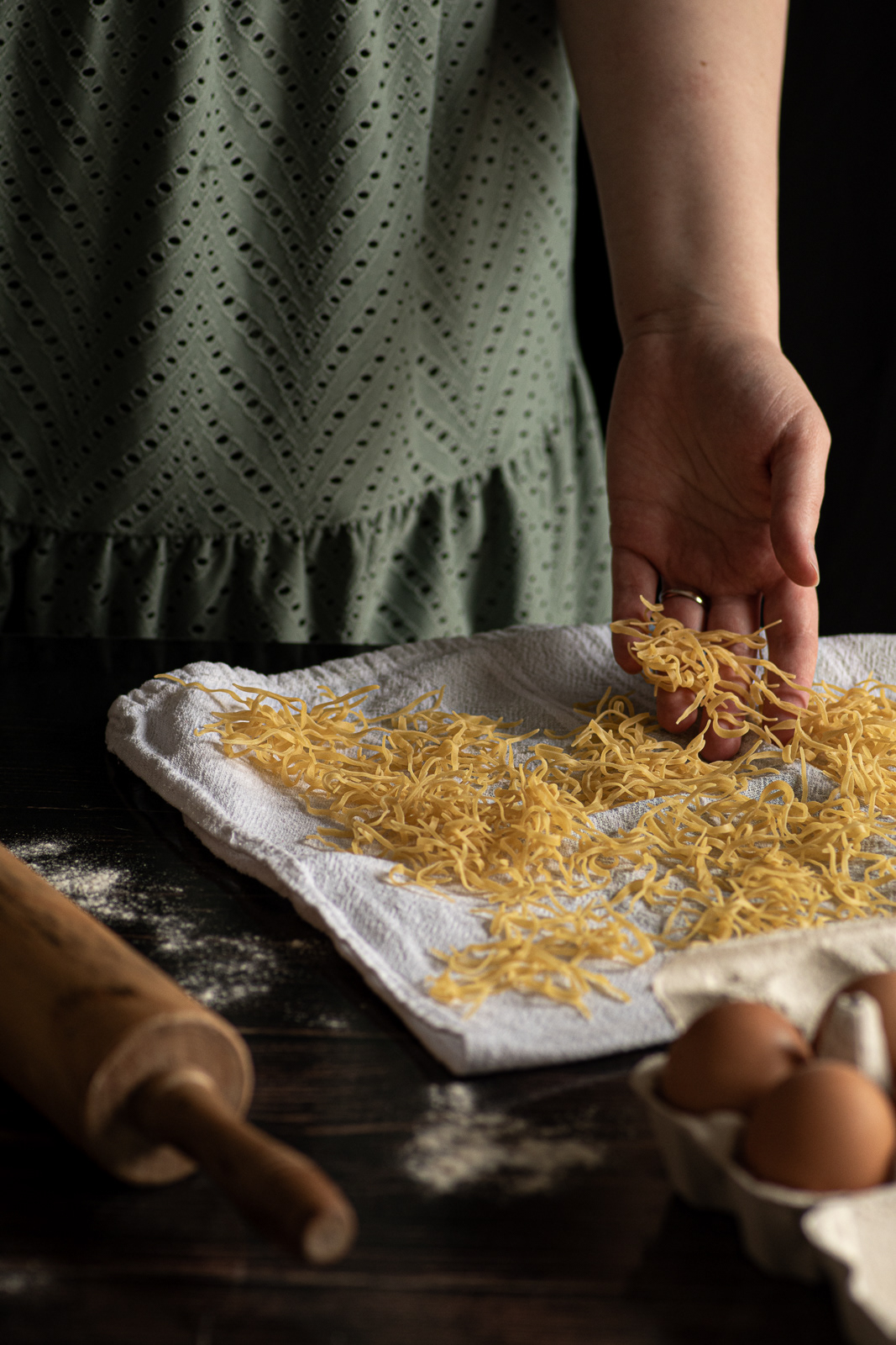 making the homemade pasta, eggs, a white linen and a pinwheel