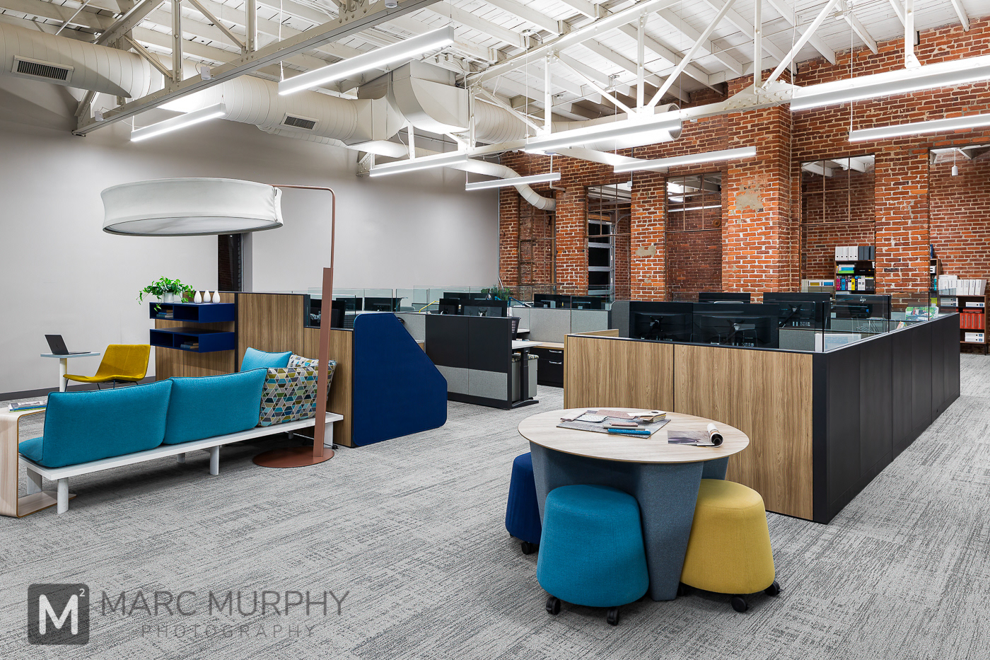 Workspace Interiors Open Work Cubicle Workstation area with cubicles, desks, tables, chairs open ceiling and brick walls