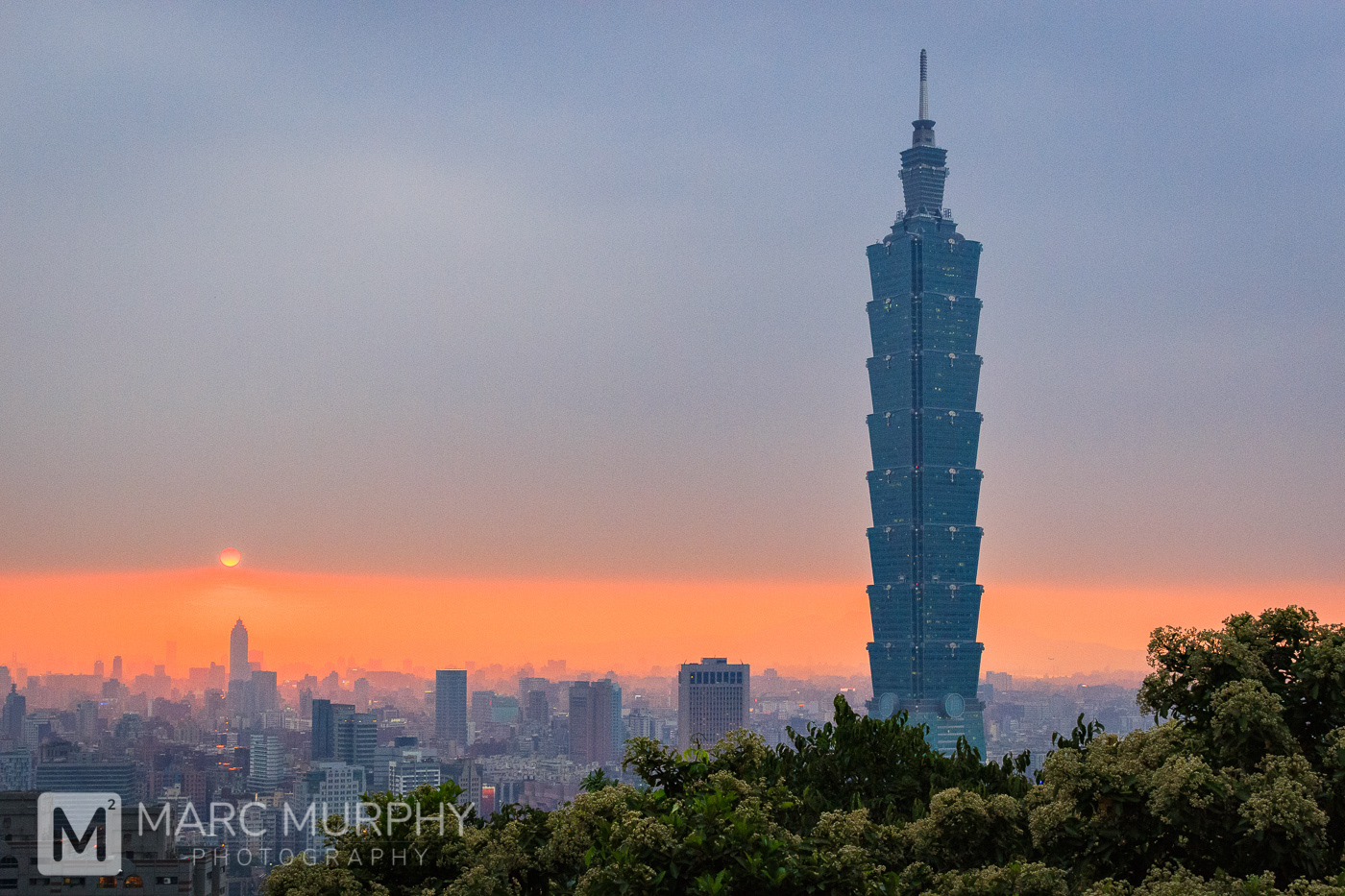 Downtown Taipei Taiwan Skyline in Spring at Sunset with Taipei 101, Other Tall Buildings, the Sun and Orange Sky