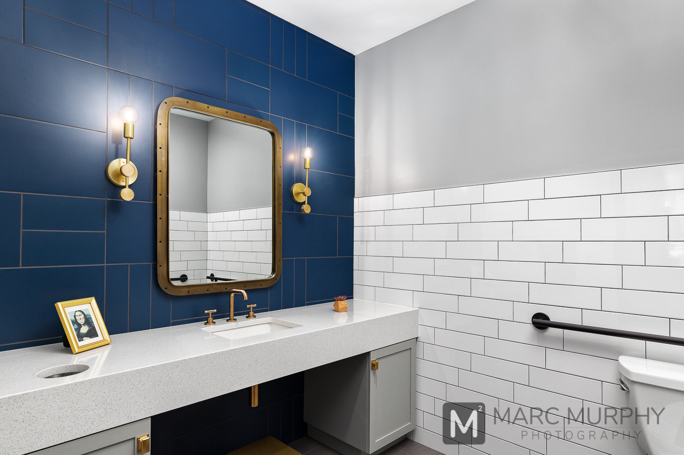 Sturgill Orthodontics Office Restroom Bathroom with White Subway Tile Navy Blue Wall Tile, Mirror and Wall Sconces