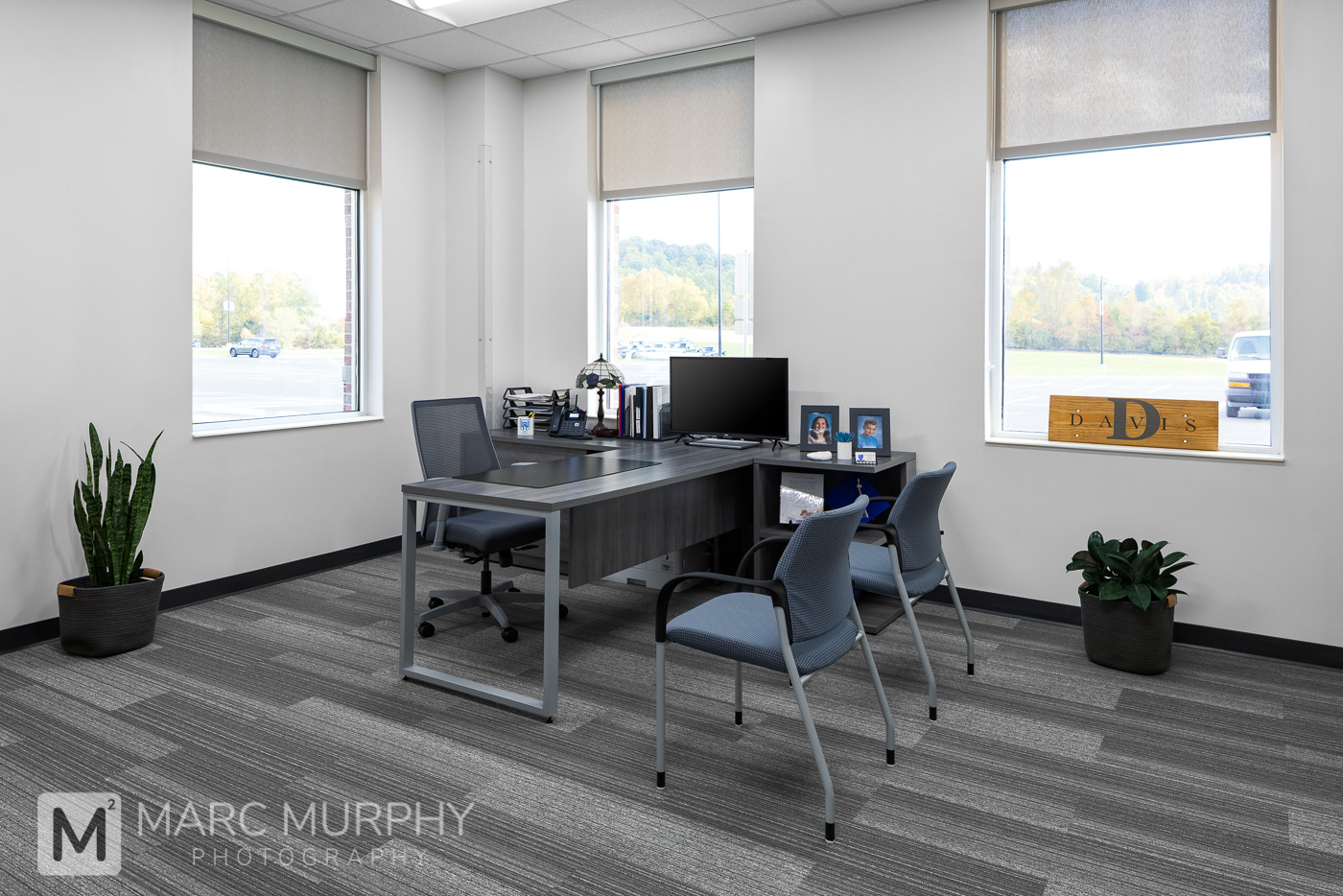 West Ridge High School Principal's Office with desk, chairs, plants and windows