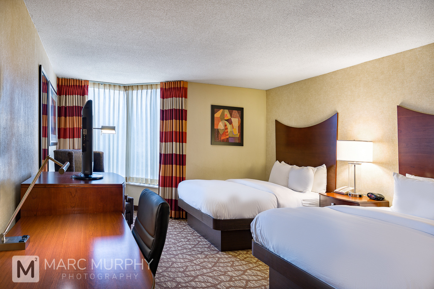 Double Tree by Hilton Johnson City Hotel Bedroom With Two Beds, Lamp, Desk and Flat Screen TV Television