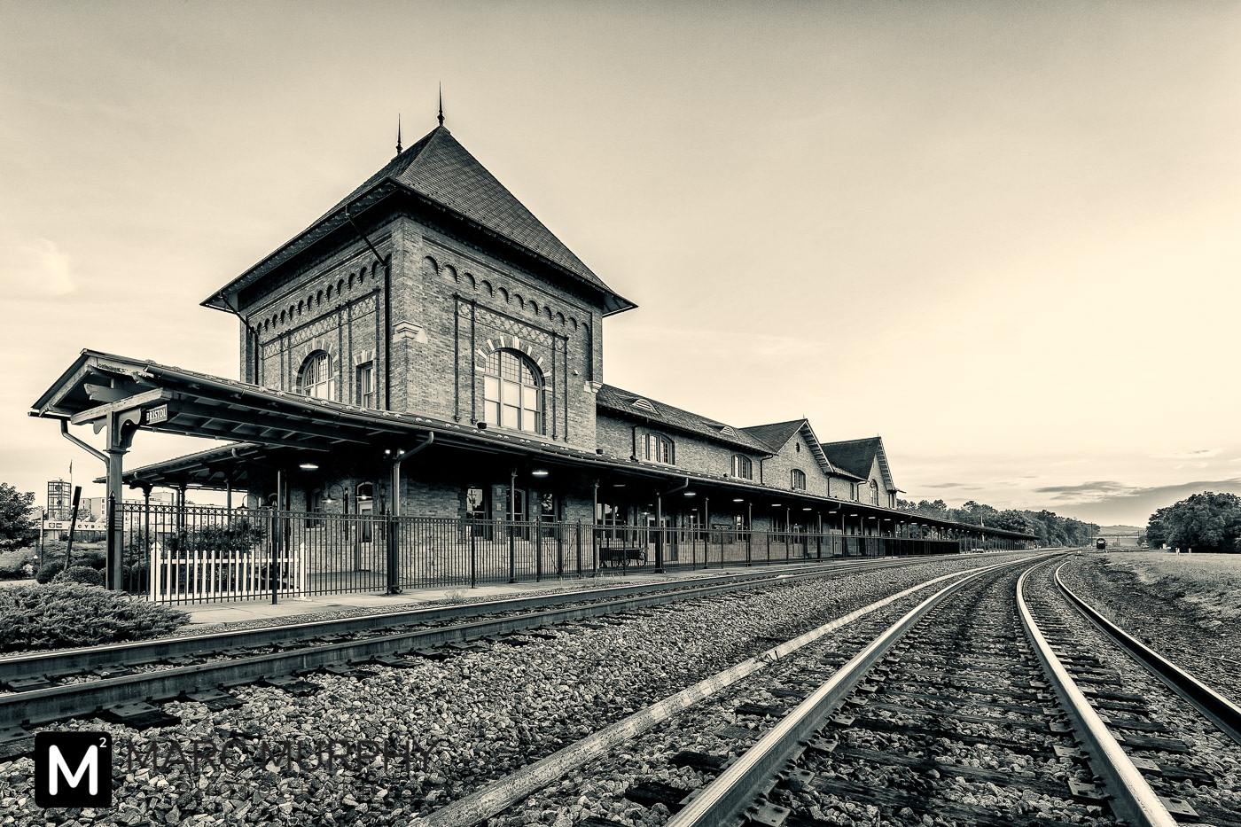 Black and White Downtown Bristol Tennessee and Virginia Train Station at Sunrise with Rail Lines Leading Away