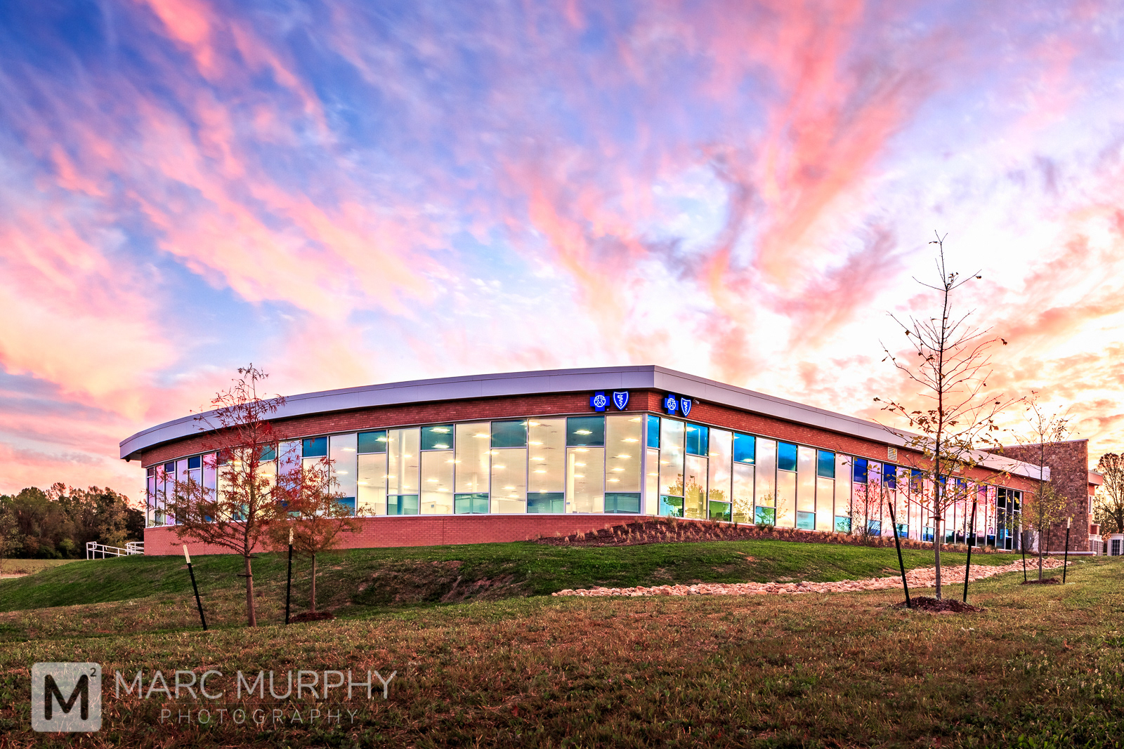 Blue Cross Blue Shield Brick and Glass Office Building at Sunset with Pink, Purple, Orange, Yellow and Blue Clouds and Sky