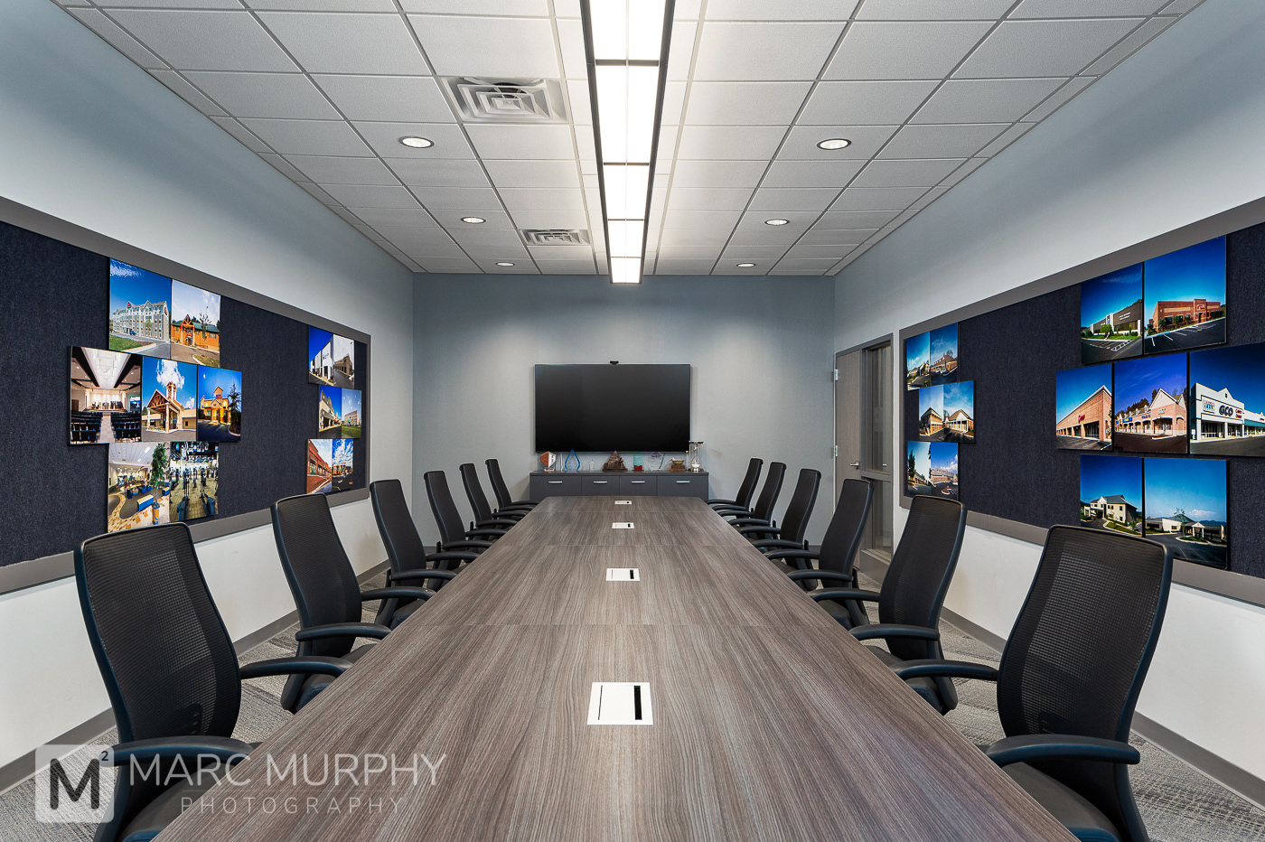 Corporate Office Conference Room with Conference Table, Black Chairs and TV on Wall