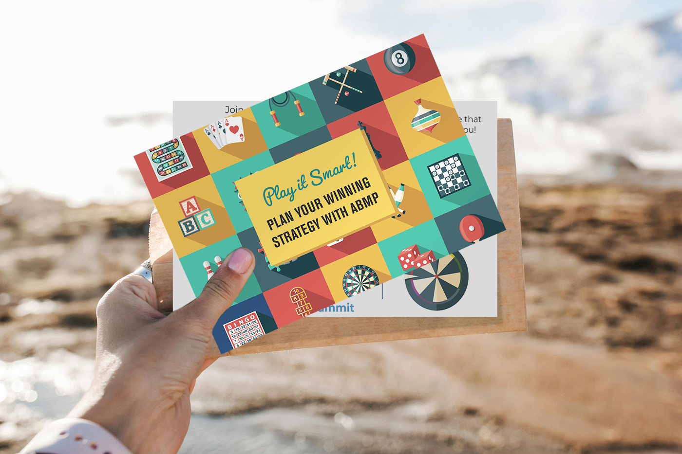 ABMP student summit postcard being held up in front of a beach scene. Original image by Pavel Danilyuk via Pexels