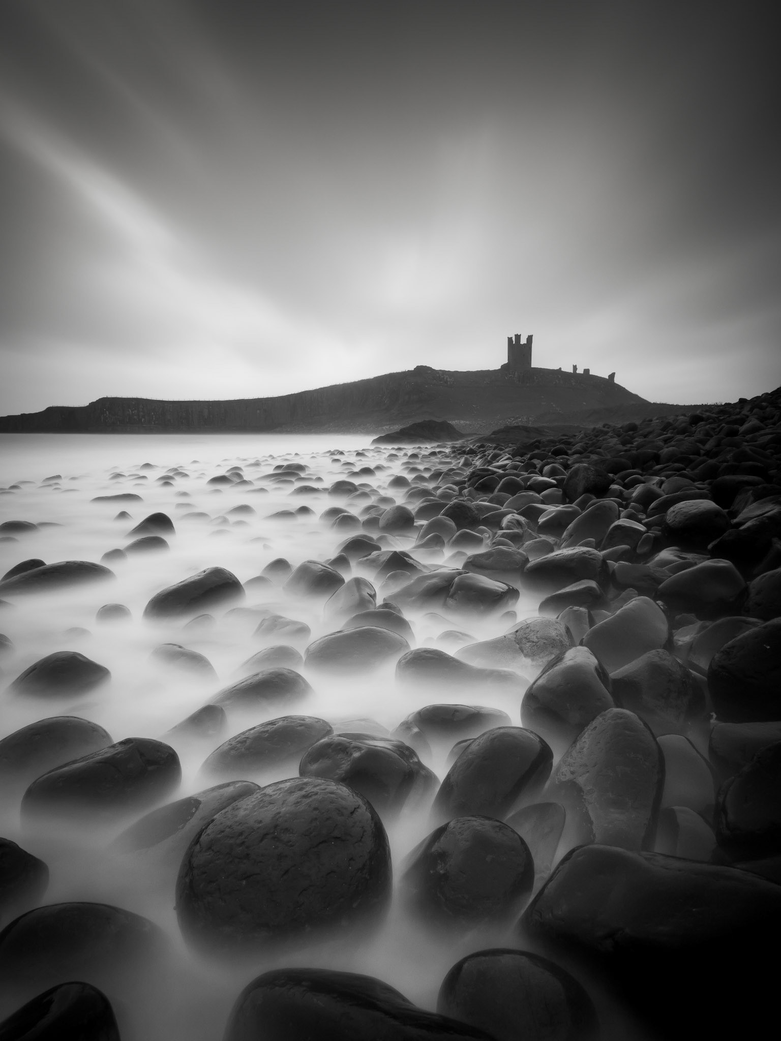 Dunstanburgh Castle from boulder beach