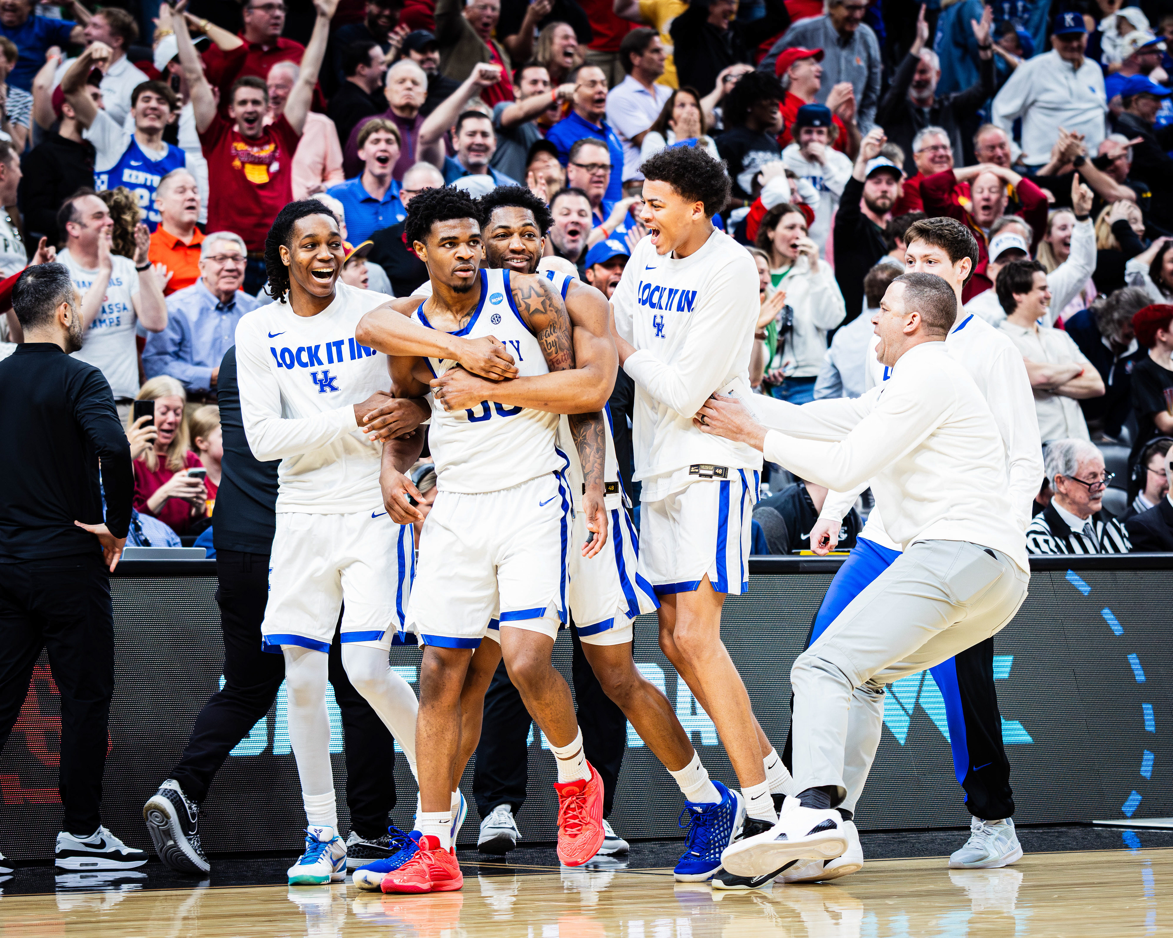 Kentucky basketball player Otega Oweh is swarmed by the team after Oweh hit the game-tying three-pointer at the buzzer of the second half of the March Madness Round of 64 game against Santa Clara, at the Enterprise Center, located in St. Louis, Missouri, on March 20, 2026.
