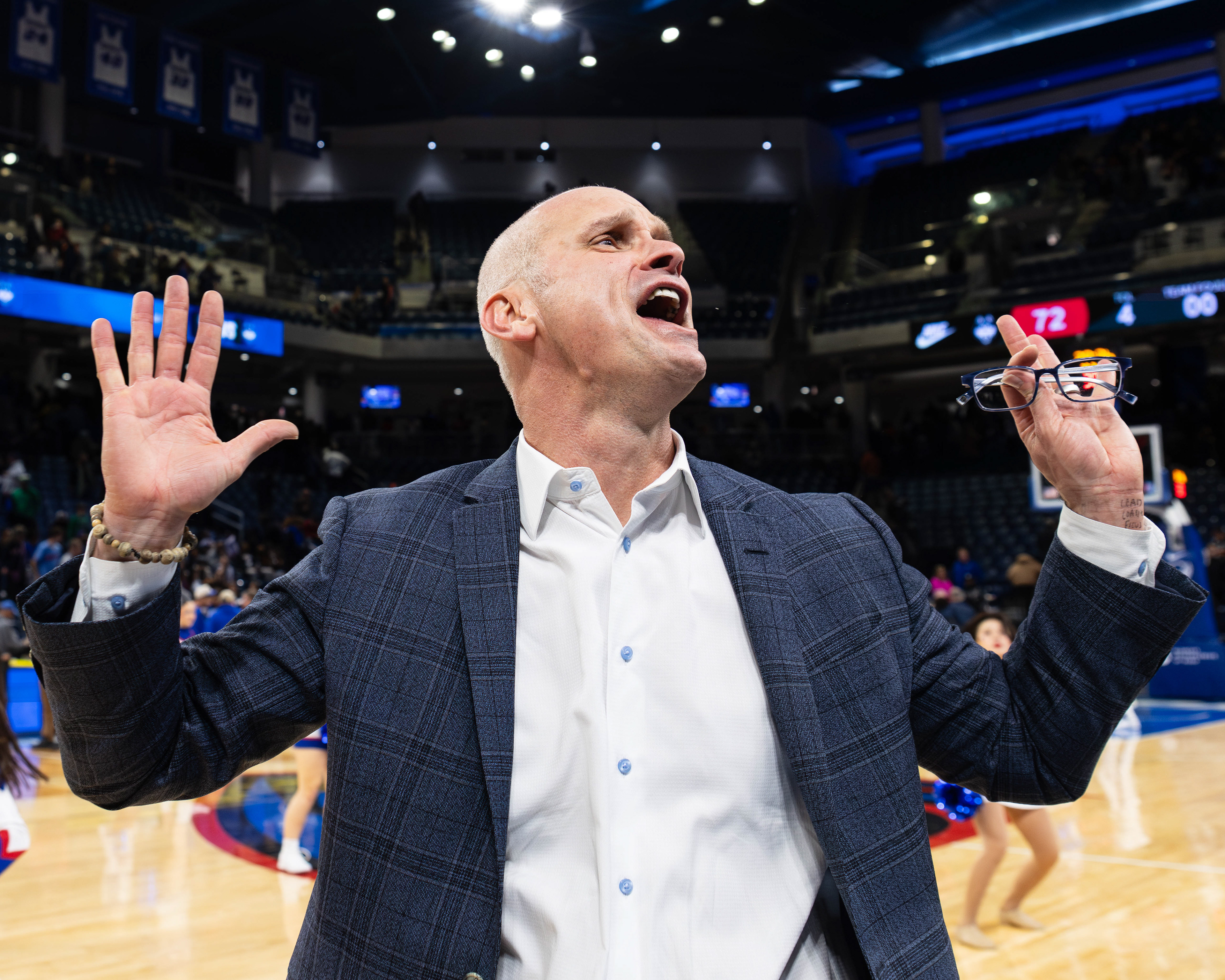UConn men's basketball head coach Dan Hurley celebrates with fans after defeating DePaul by a score of 72-54, at Wintrust Arena, located in Chicago, Illinois, on December 21, 2025.