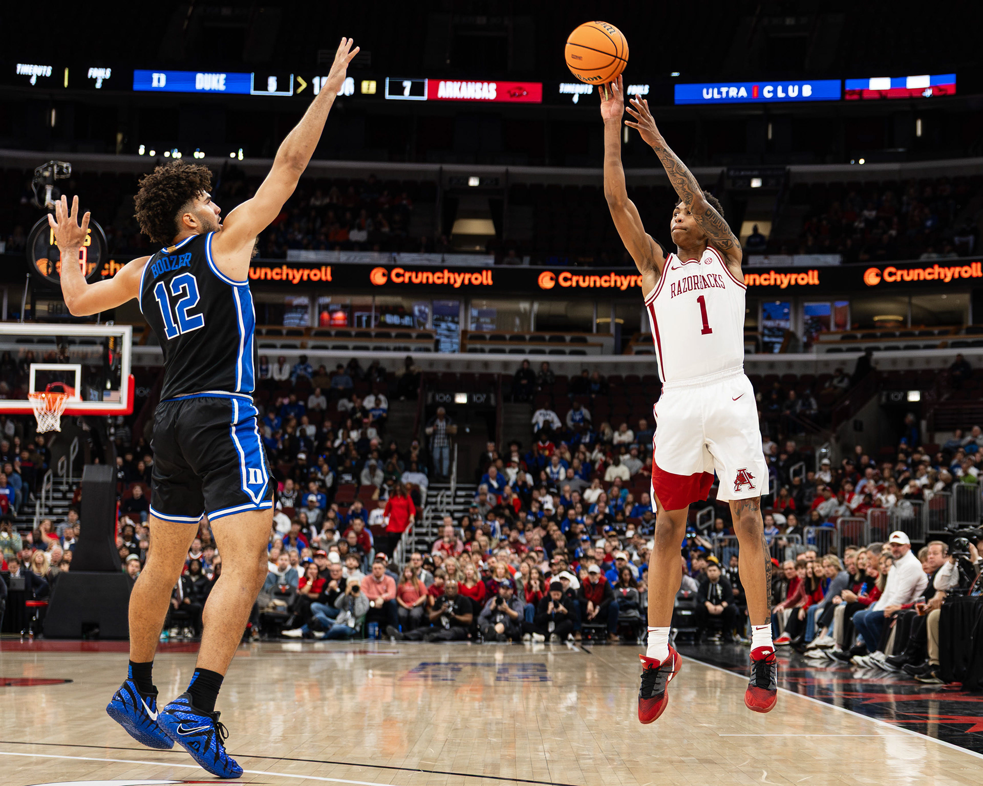 Arkansas basketball player Meleek Thomas shoots a three-pointer over Cameron Boozer in the CBS Sports Thanksgiving Classic game against Duke, at the United Center, located in Chicago, Illinois, on November 27, 2025.