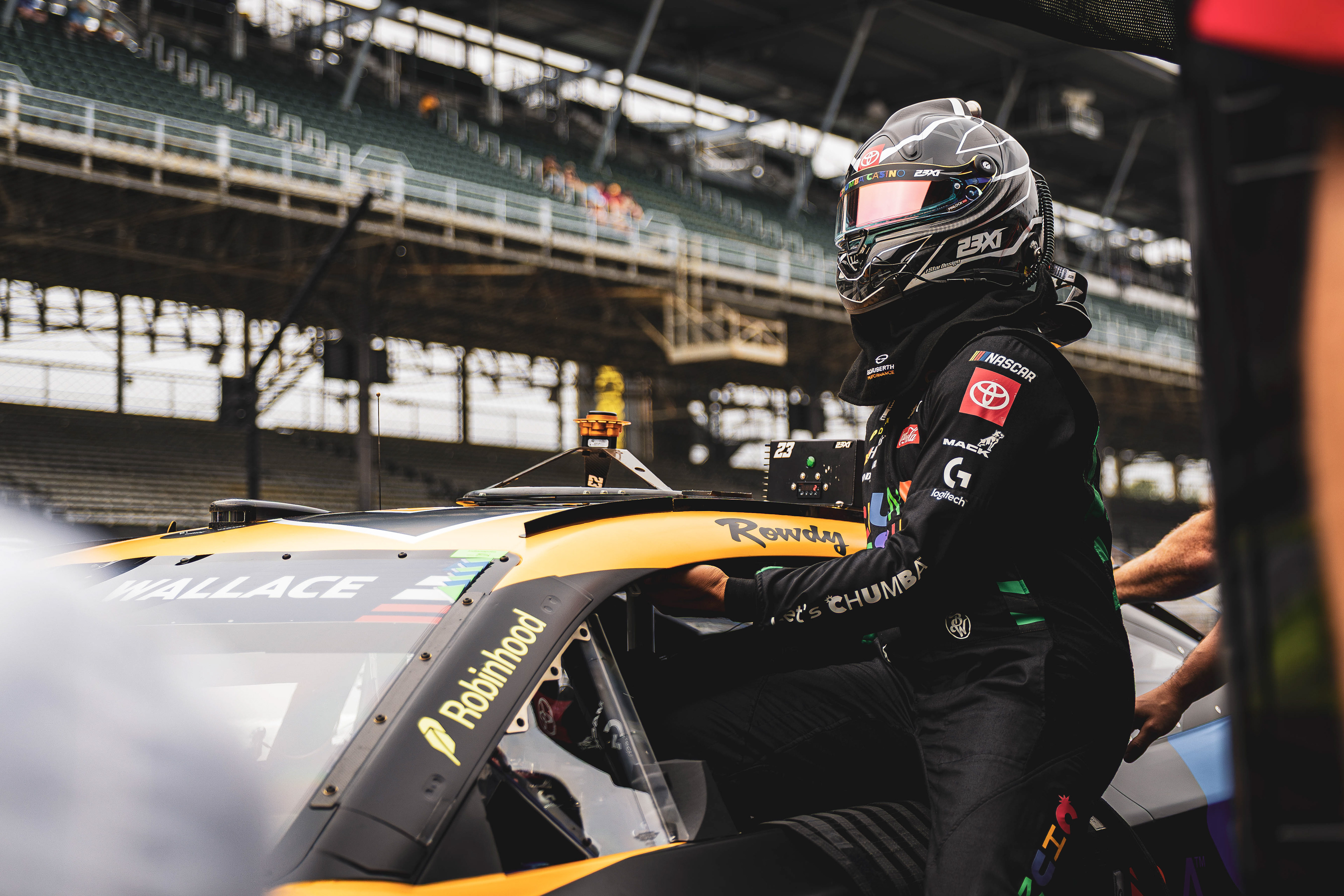 Bubba Wallace, driver of the No. 23 Toyota for 23XI Racing, climbs into his car to qualify for the Brickyard 400, at the Indianapolis Motor Speedway, located in Speedway, Indiana, on July 25, 2026.